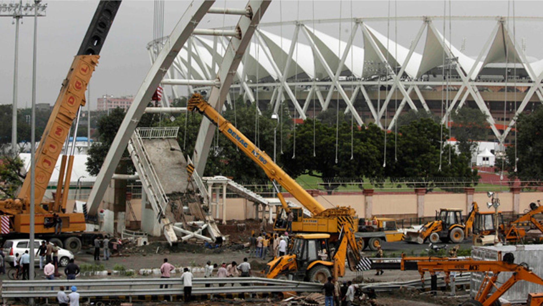 Sept. 22: A crane lifts debris from a pedestrian bridge that collapsed outside the Jawaharlal Nehru Stadium, the main venue for the Commonwealth Games, in New Delhi, India.