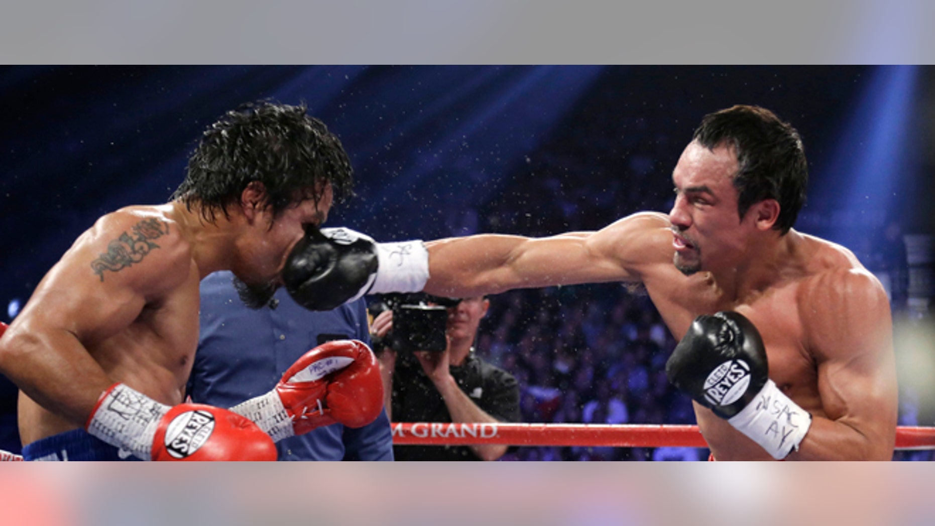 Juan Manuel Marquez, from Mexico, right, lands a right to the head of Manny Pacquiao, from the Philippines, during their WBO world welterweight fight Saturday, Dec. 8, 2012, in Las Vegas. Marquez won by a knockout. (AP Photo/Julie Jacobson)