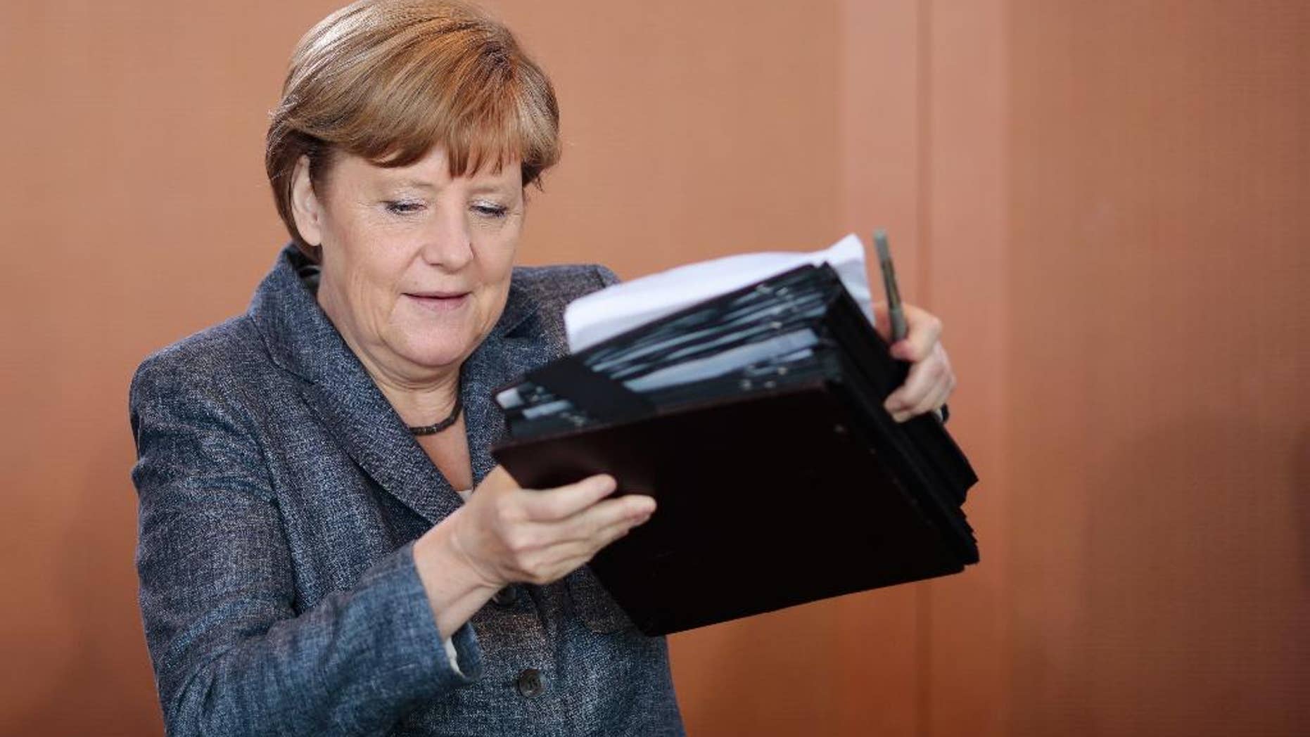 German Chancellor Angela Merkel arrives for the beginning of German government's weekly cabinet meeting at the chancellery in Berlin, Germany, Wednesday, June 3, 2015. (AP Photo/Markus Schreiber)