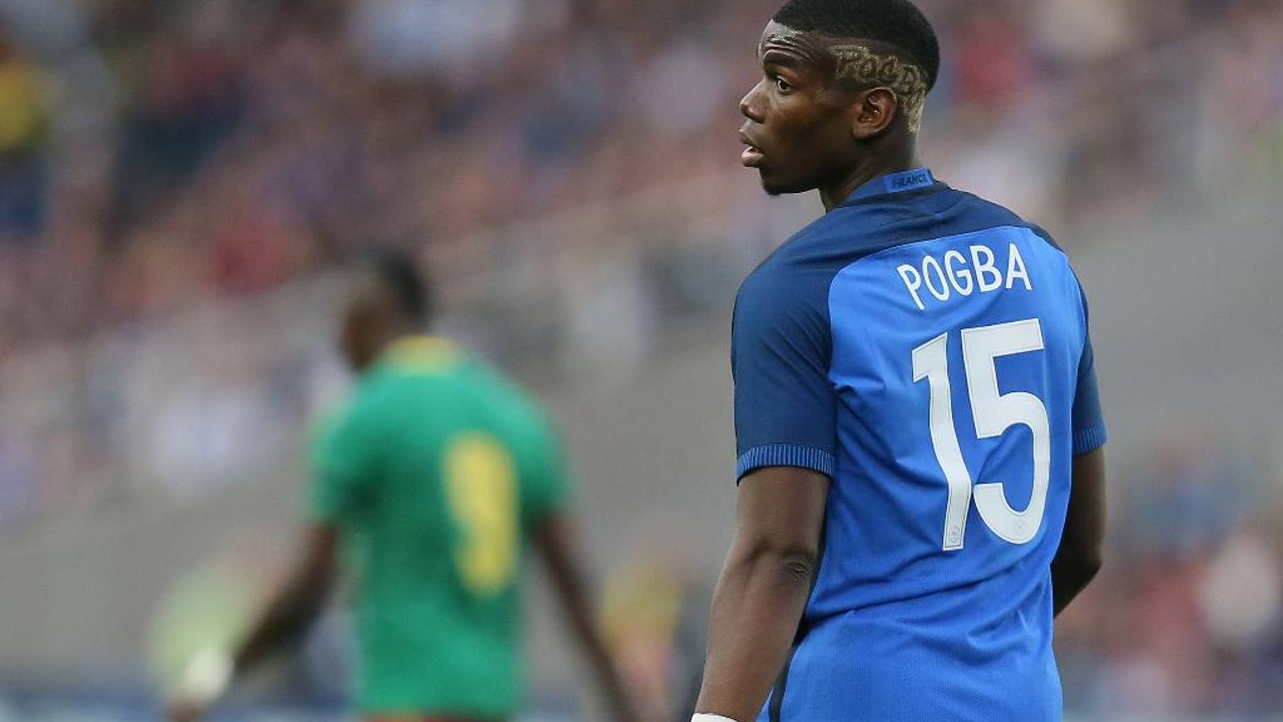 FILE - In this Monday, May 30, 2016 file photo, France's Paul Pogba looks on during a friendly soccer match between France and Cameroon at the La Beaujoire Stadium in Nantes, western France. Manchester United says Paul Pogba has been granted permission to have a medical examination to finalize his transfer to the English club from Juventus. United made the announcement in a one-line statement on Sunday, Aug. 7, 2016 under the hashtag “Pogback.” (AP Photo/David Vincent, file)