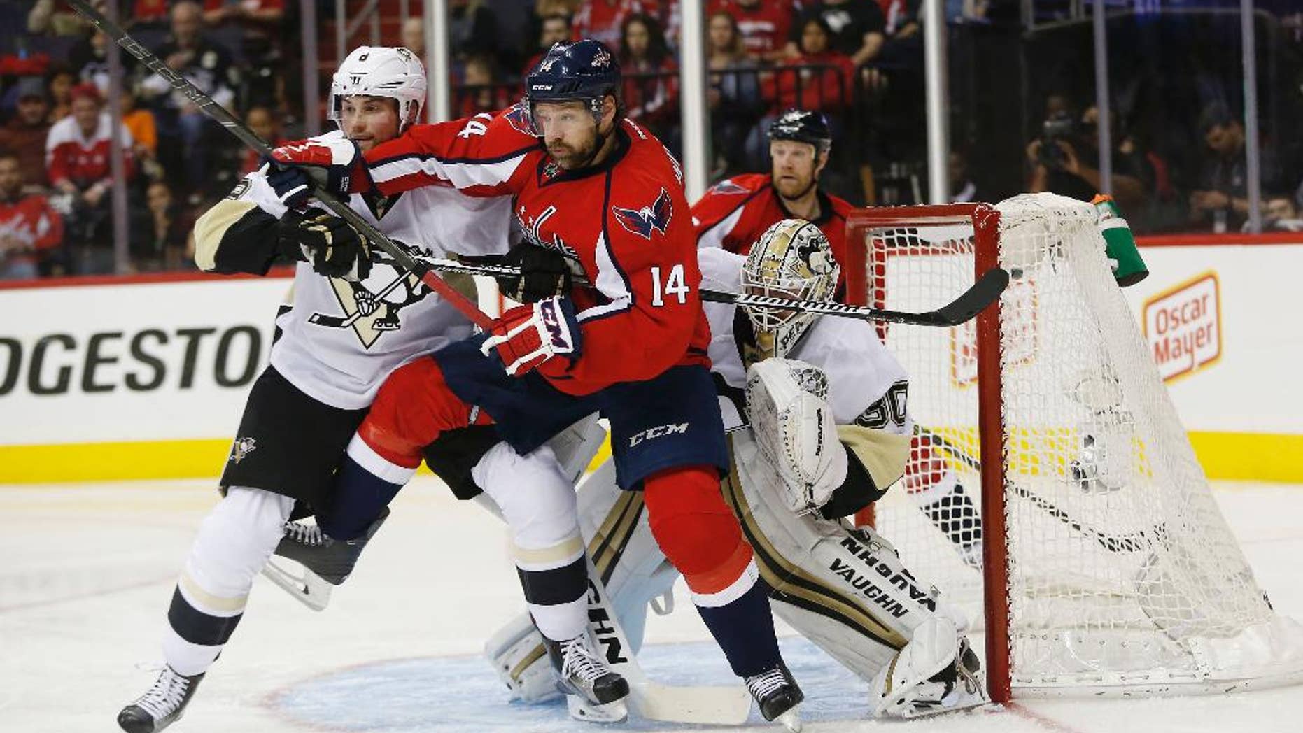 Washington Capitals right wing Justin Williams (14) and Pittsburgh Penguins defenseman Brian Dumoulin (8) shove each other as they work in front of Pittsburgh Penguins goalie Matt Murray (30) during the second period of Game 5 in an NHL hockey Stanley Cup Eastern Conference semifinals Saturday, May 7, 2016, in Washington. (AP Photo/Pablo Martinez Monsivais)