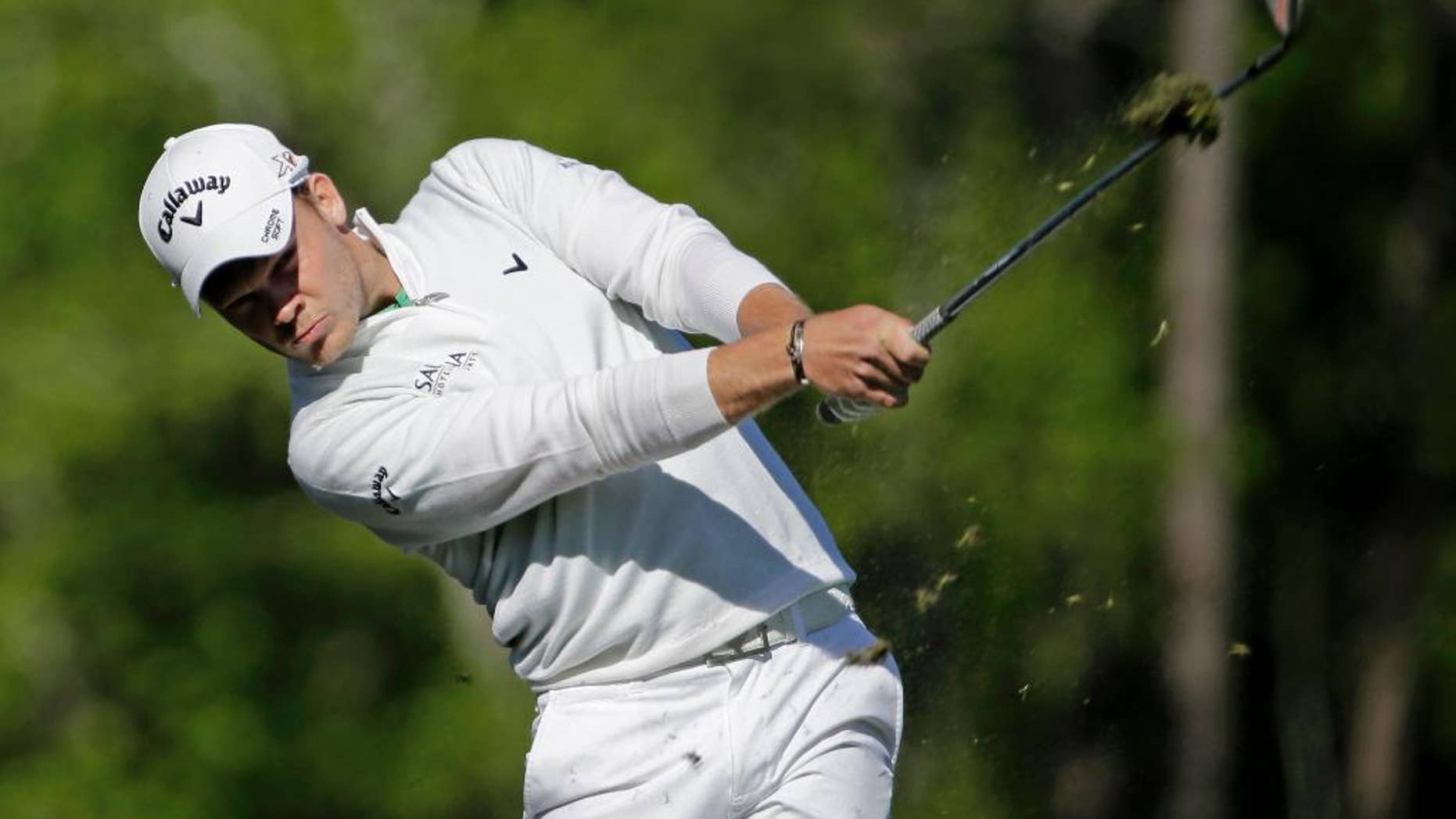 FILE - In this Sunday, April 10, 2016 file photo, Danny Willett, of England, tees off on the 12th hole during the final round of the Masters golf tournament in Augusta, Ga. Masters champion Danny Willett has been away from golf for a month and has been working harder than ever. Not with his golf clubs, but with a pen. (AP Photo/David J. Phillip, File)