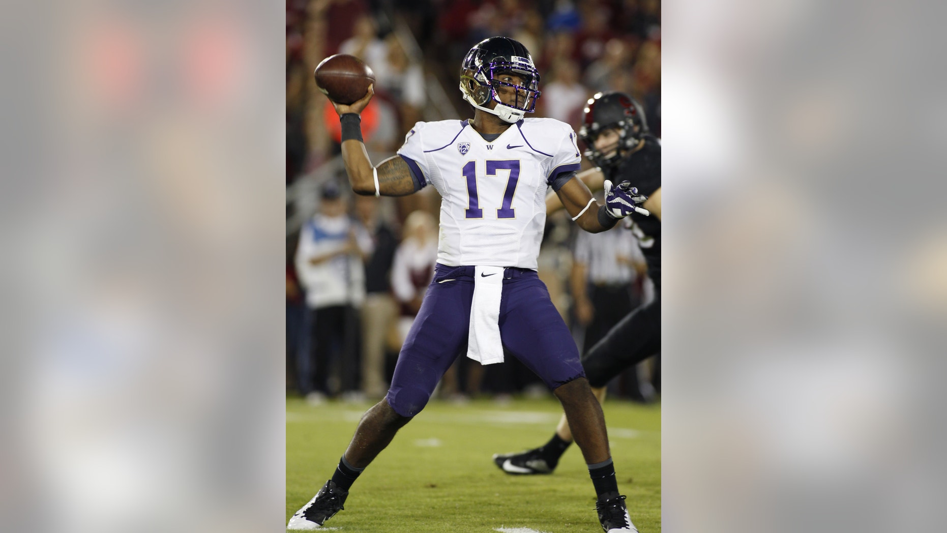 Washington quarterback Keith Price throws a pass against Stanford during the first half of an NCAA college football game in Stanford, Calif., Saturday, Oct. 5, 2013. (AP Photo/George Nikitin)