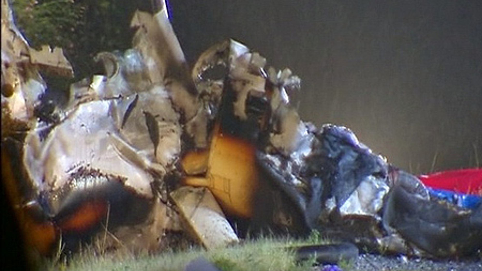 July 24: Wreckage of a Robinson R-44 helicopter is removed from the eastbound lanes of Interstate 70.