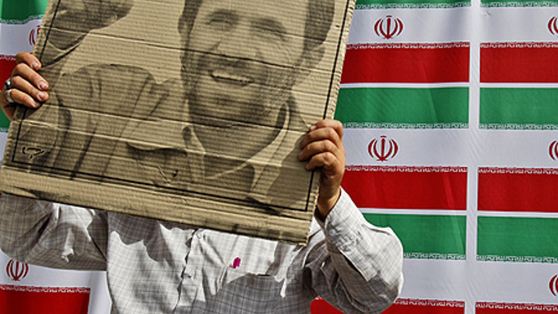 June 10: A supporter of Mahmoud Ahmadinejad holds the president's poster during a rally in west Tehran.