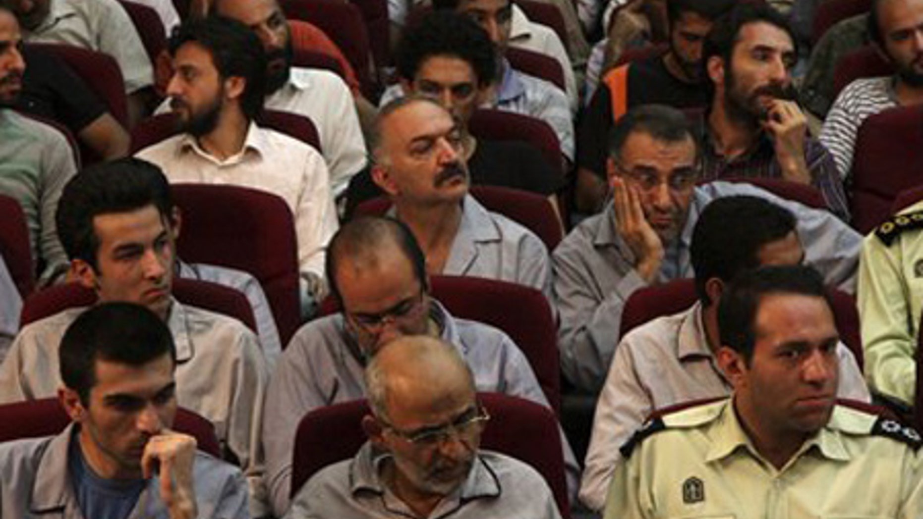 Aug. 1: Defendants sit in a court room in Tehran, Iran.