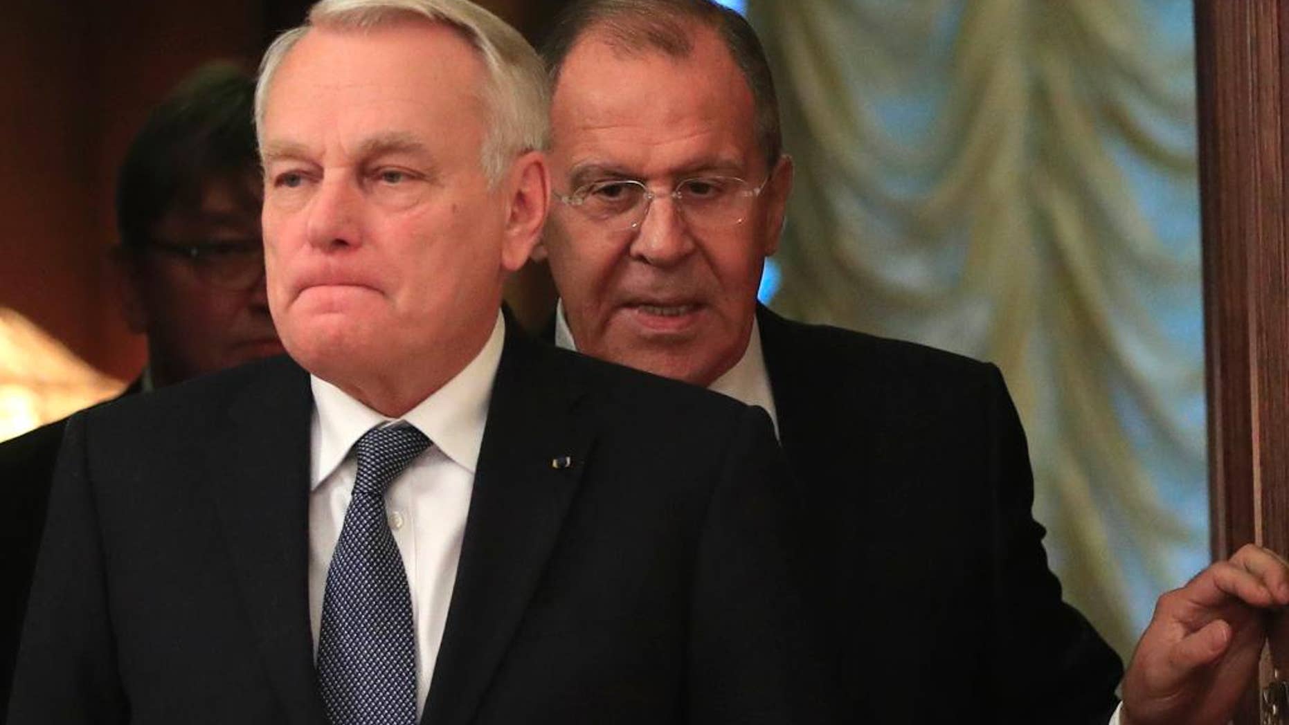 FILE - In this Oct. 6, 2016 file photo, Russian Foreign Minister Sergey Lavrov, right, meets with French Foreign Minister Jean-Marc Ayrault in Moscow. Ayrault, speaking on Monday, Oct. 10, 2016, called on the International Criminal Court to investigate Russia for possible war crimes in Syria. (AP Photo/Pavel Golovkin, File)