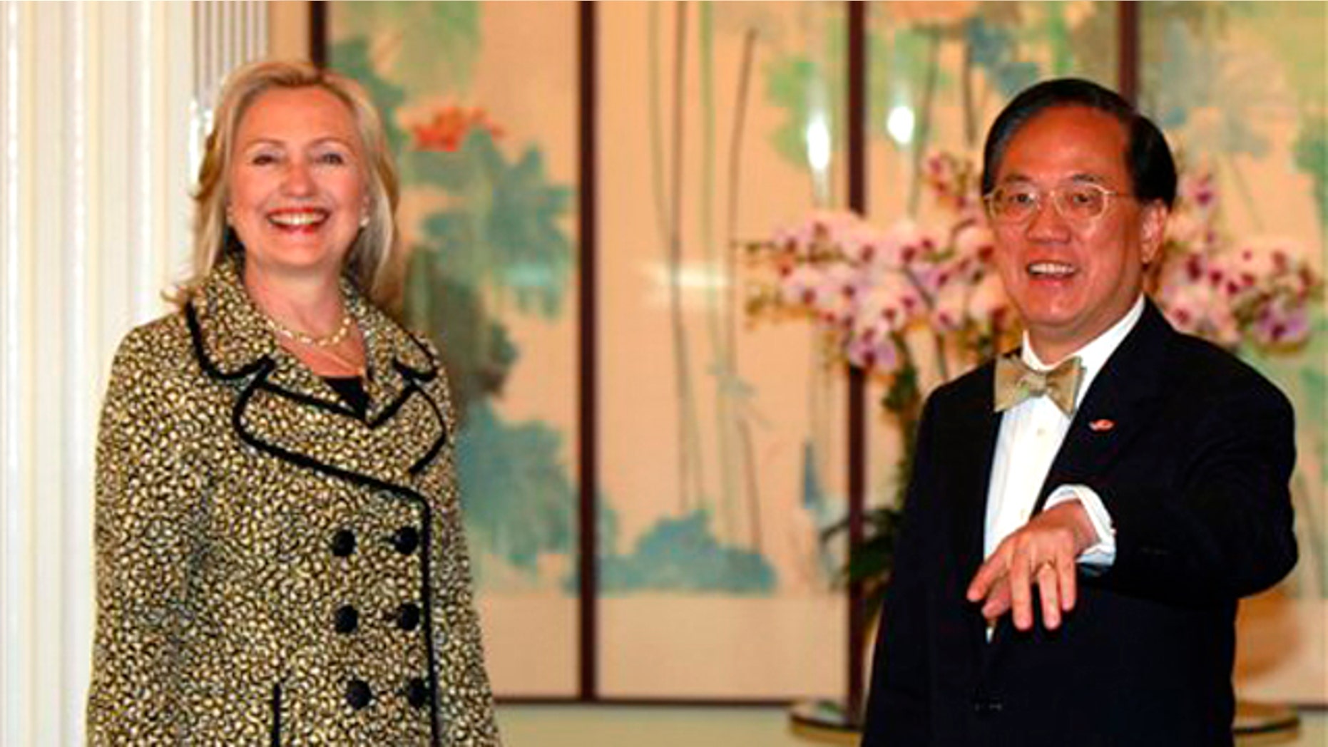 Hong Kong's Chief Executive Donald Tsang, right, greets U.S. Secretary of State Hillary Rodham Clinton at Government House in Hong Kong, China, Monday, July 25, 2011.