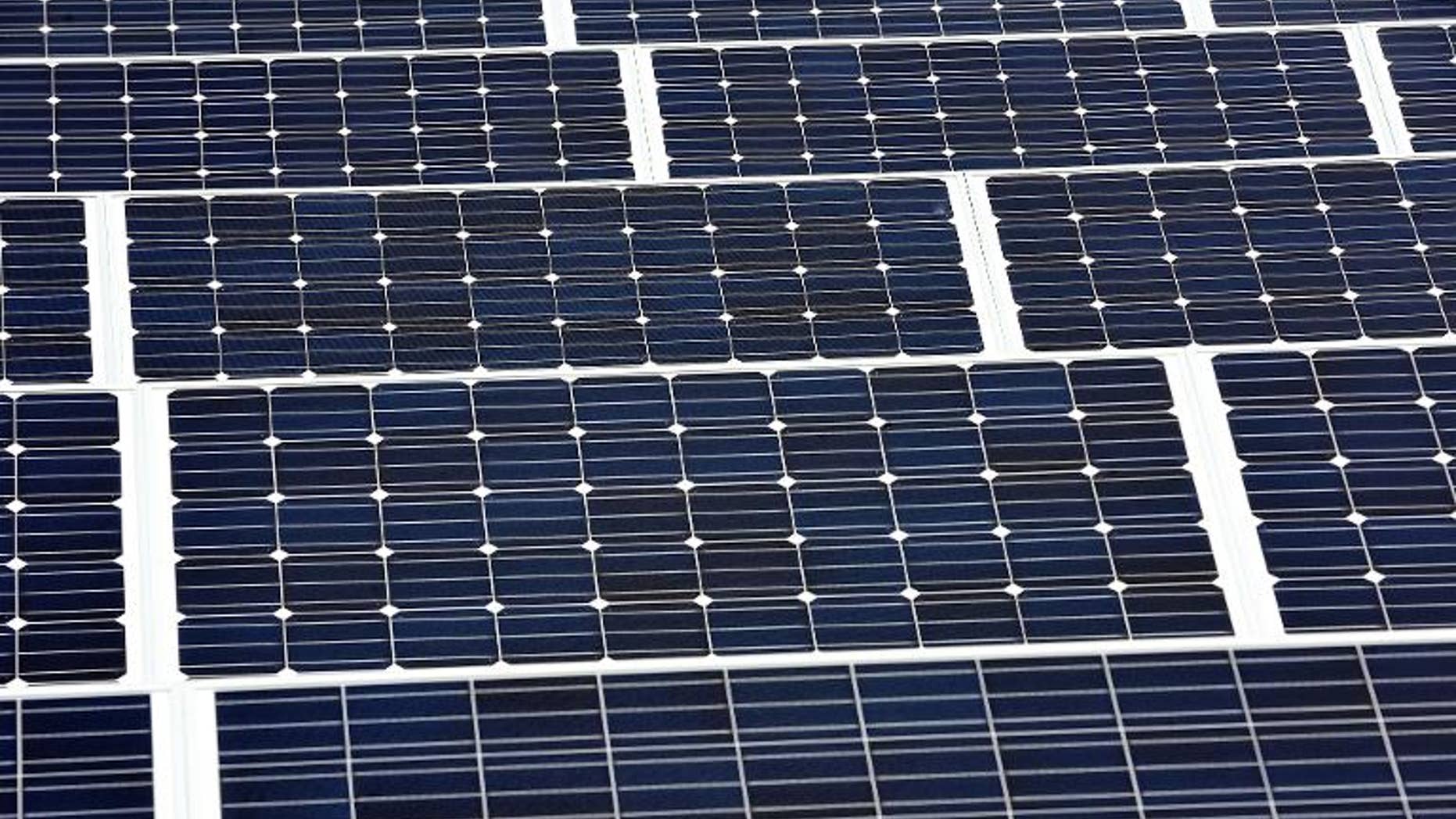 Solar panels are installed on the roof of a building in Lille on September 9, 2013