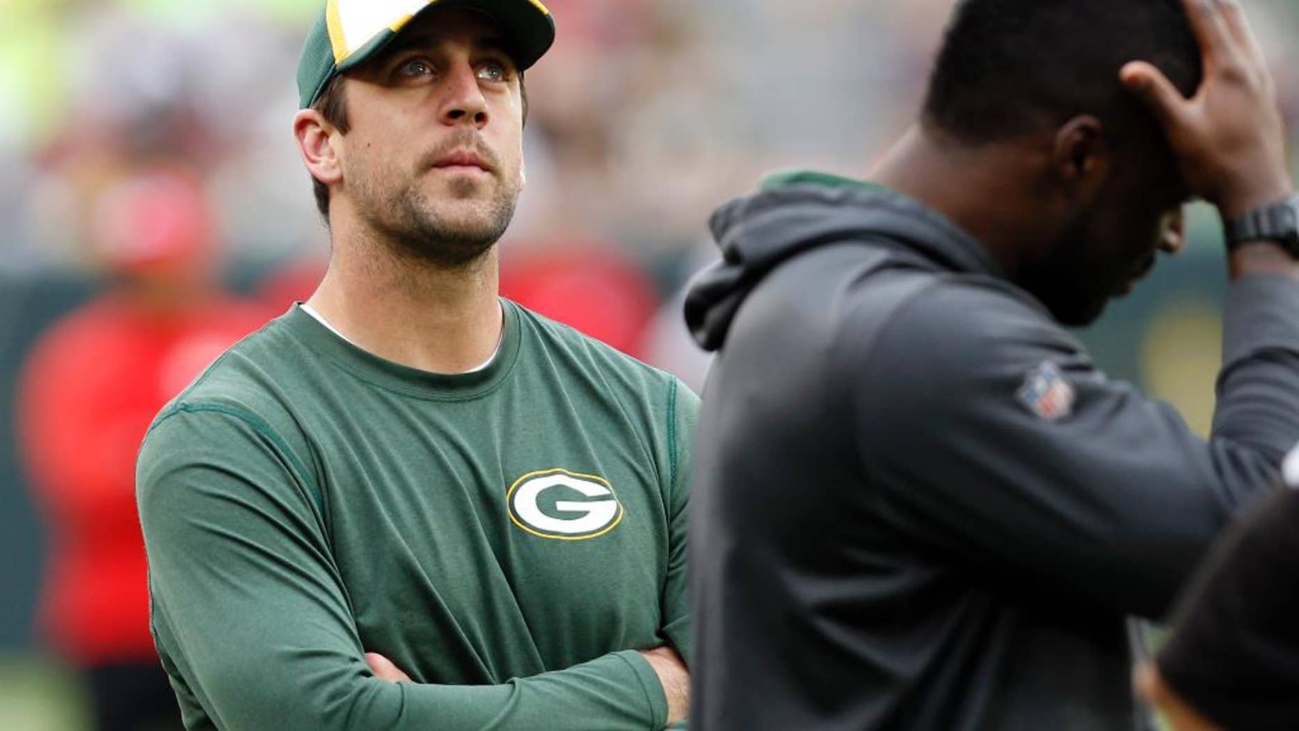 Green Bay Packers quarterback Aaron Rodgers watches teammates warm-up before an NFL football preseason game against the Kansas City Chiefs Thursday, Aug. 28, 2014, in Green Bay, Wis. Rodgers and other starters are not expected to play in the game. (AP Photo/Mike Roemer)
