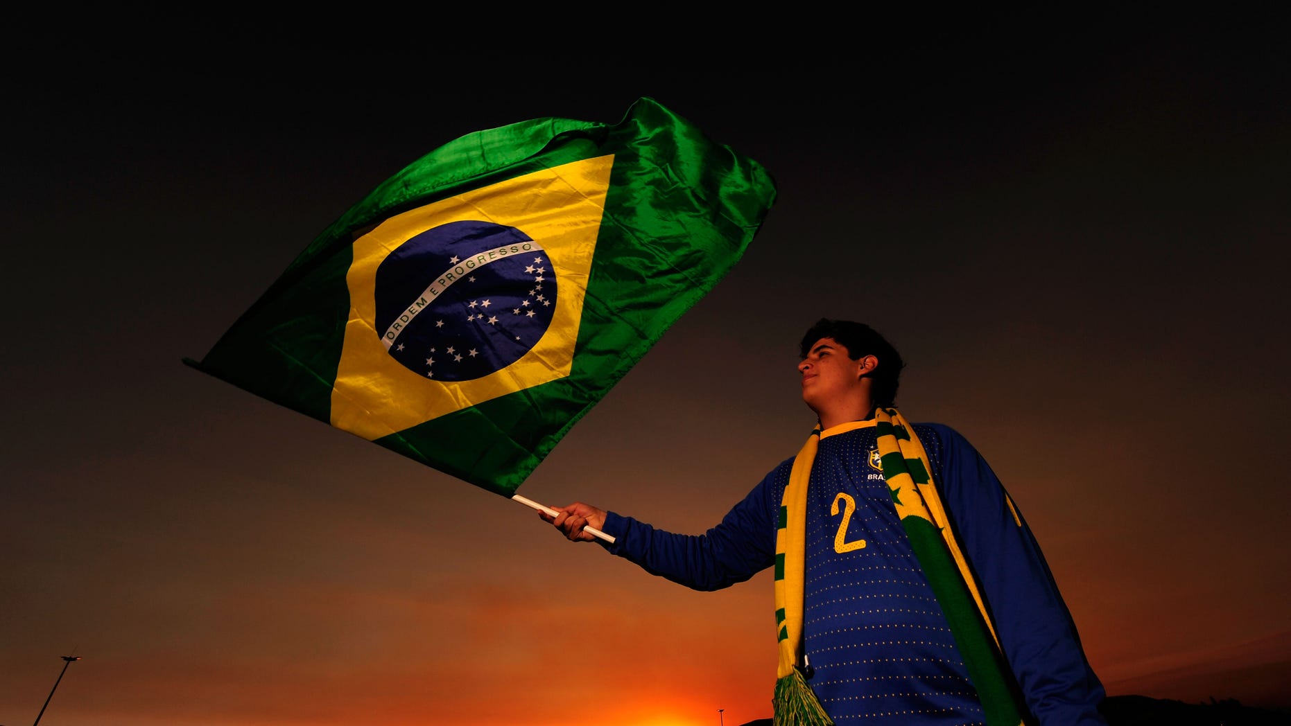 JOHANNESBURG, SOUTH AFRICA - JUNE 20: A Brazil fan waves her national flag ahead of the 2010 FIFA World Cup South Africa Group G match between Brazil and Ivory Coast at Soccer City Stadium on June 20, 2010 in Johannesburg, South Africa. (Photo by Stuart Franklin/Getty Images)