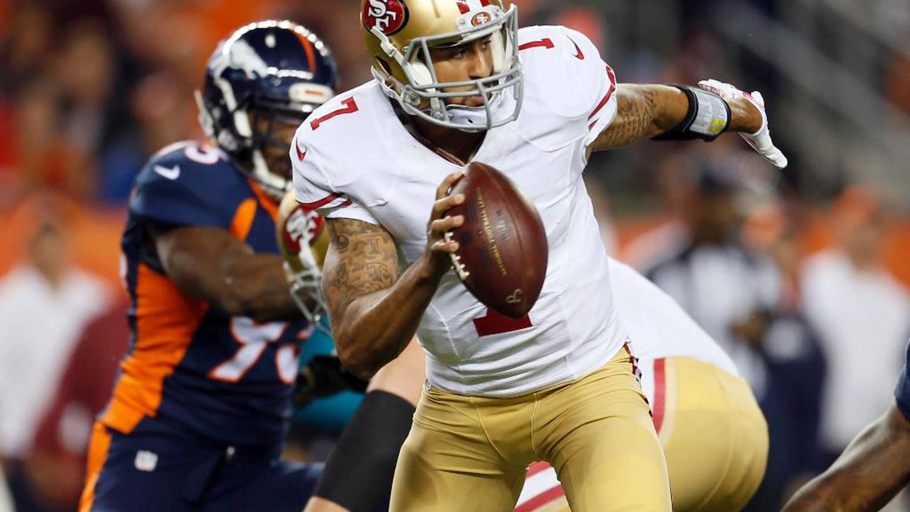 San Francisco 49ers quarterback Colin Kaepernick (7) is hurried against the Denver Broncos during the first half of an NFL football game, Sunday, Oct. 19, 2014, in Denver. (AP Photo/Joe Mahoney)