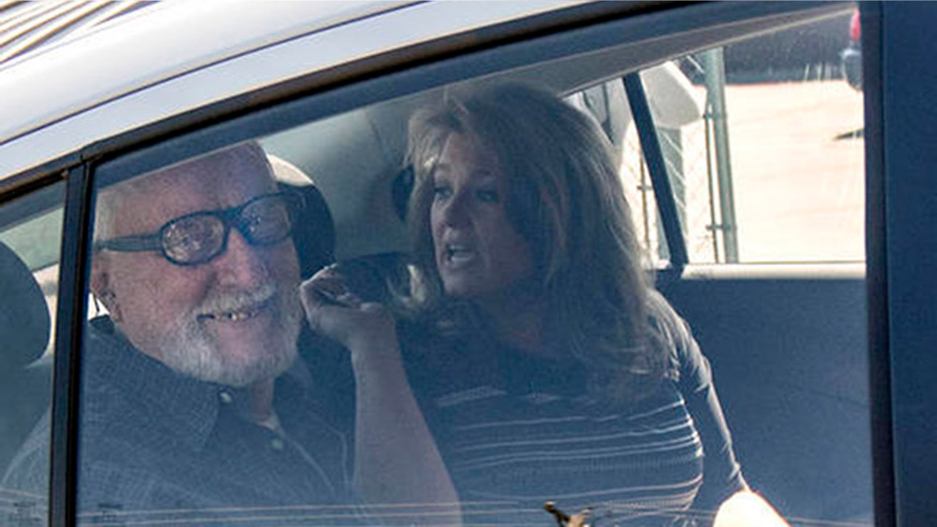 Jack McCullough, left, smiles from the backseat of his stepdaughter Janey O'Connor's rental car after he was released from the DeKalb County Jail in Sycamore, Ill., Friday, April 15, 2016. An Illinois judge vacated the conviction of the 76-year-old man in a 1957 killing and ordered his immediate release from prison Friday, meaning that one of the oldest cold cases to be tried in U.S. history has officially gone cold again. (Danielle Guerra/Daily Chronicle via AP) MANDATORY CREDIT; CHICAGO TRIBUNE OUT