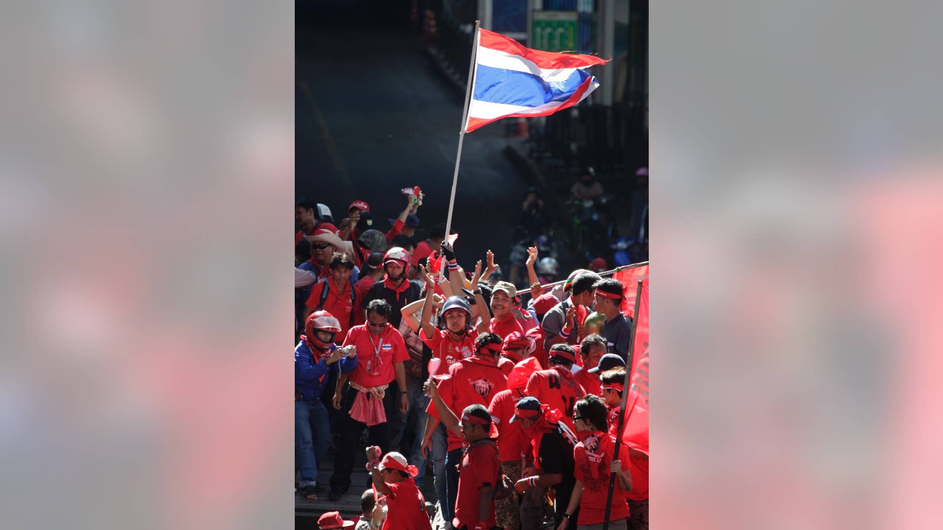 FILE - In this April 12, 2009, file photo, "Red Shirt" demonstrators take to the streets during riots in Bangkok. A Thai court sentenced 15 members of the "Red Shirt" political movement to four years in prison on Thursday, March 5, 2015, for inciting rioting that disrupted an important regional conference in 2009, news reports said. (AP Photo/David Longstreath, File)