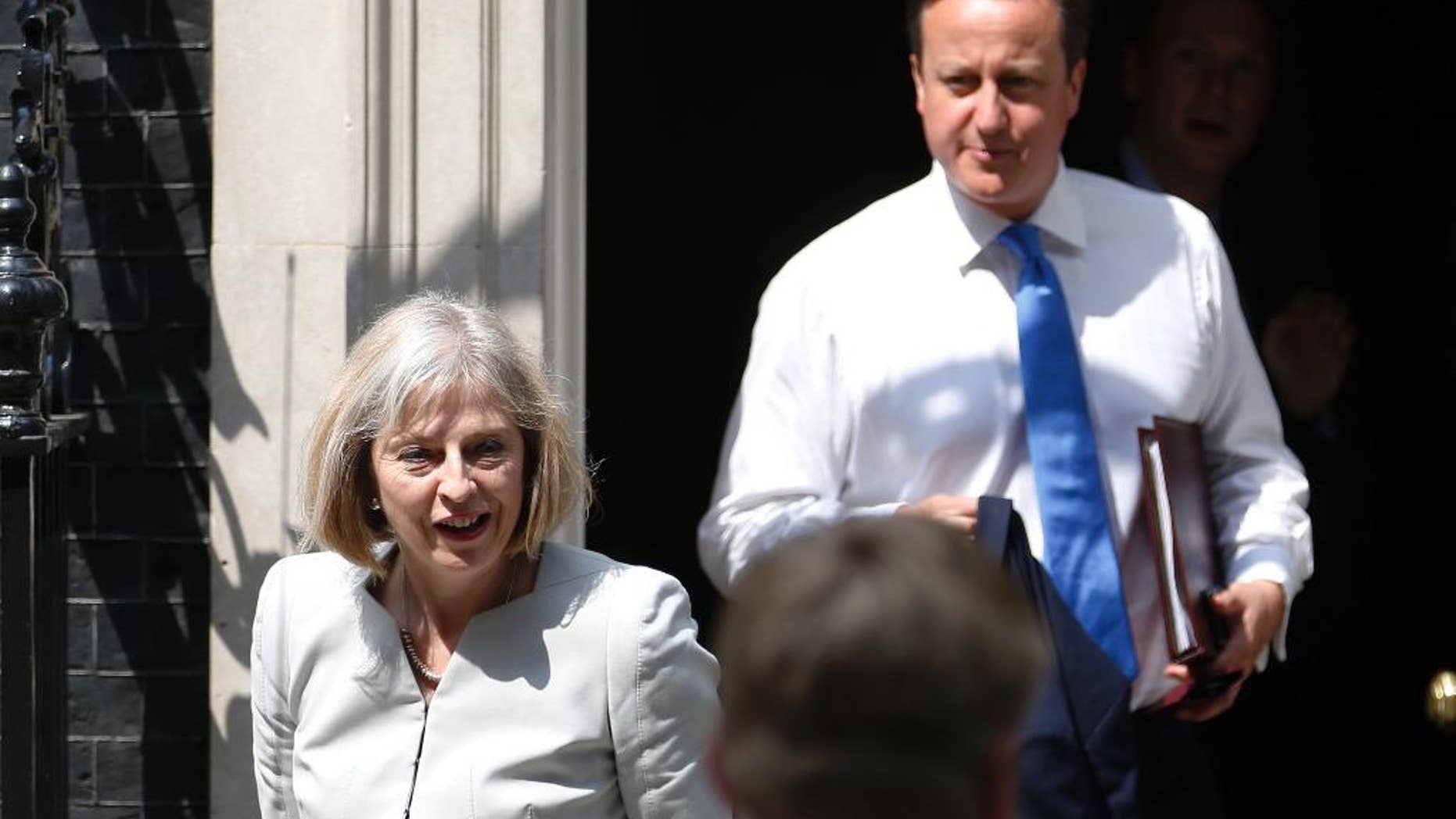 FILE - In this July 17, 2013 file photo, British Home Secretary Theresa May, left, and British Prime Minister David Cameron leave 10 Downing Street in London. A former senior British government official says May undermined Cameron in the run-up to Britain’s June 23 referendum to leave the European Union. The accusation is levied in a serialization, published Sunday, Sept. 25, 2016, of a book by Cameron’s communications director, Craig Oliver. (AP Photo/Sang Tan, File)