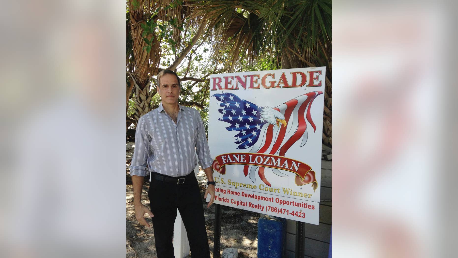 In this Feb. 24, 2017, photo, Fane Lozman stands on his property in Riviera Beach, Fla. Lozman won a 2013 U.S. Supreme Court case that affirmed that his house boat was a home and not a vessel. Lozman stands on property where he hopes to build a floating community of homes. (AP Photo/Curt Anderson)