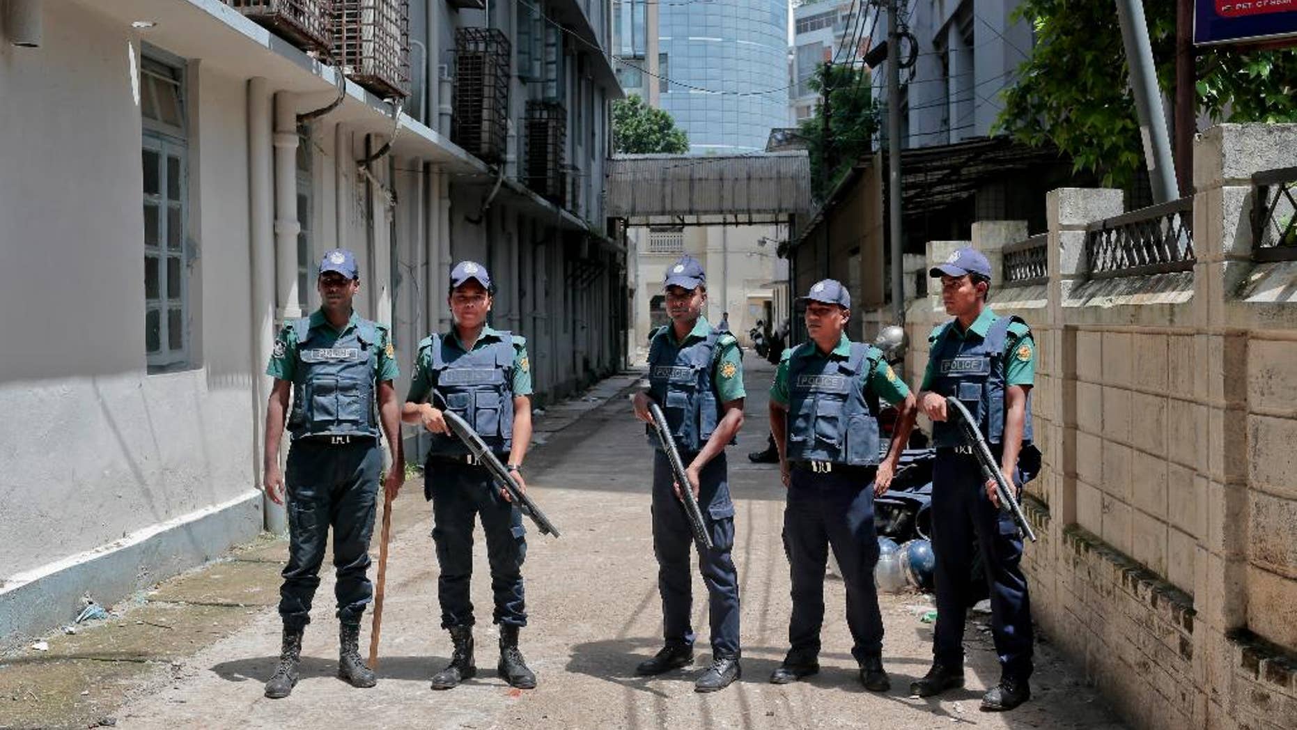 FILE - In this Wednesday, July 27, 2016, file photo, Bangladeshi policemen stand guard outside a morgue at the Dhaka Medical College Hospital during the autopsy on the bodies of suspected Islamic militants who were killed Tuesday in Dhaka, Bangladesh. A Bangladeshi father is having trouble believing that his smart, well-behaved son was among the nine suspected Islamist militants killed in the July 2016, Bangladesh police raid. He remembers his son, who held a U.S. passport, as a fun-loving student and a member of a musically inclined family who played guitar. (AP Photo, File)