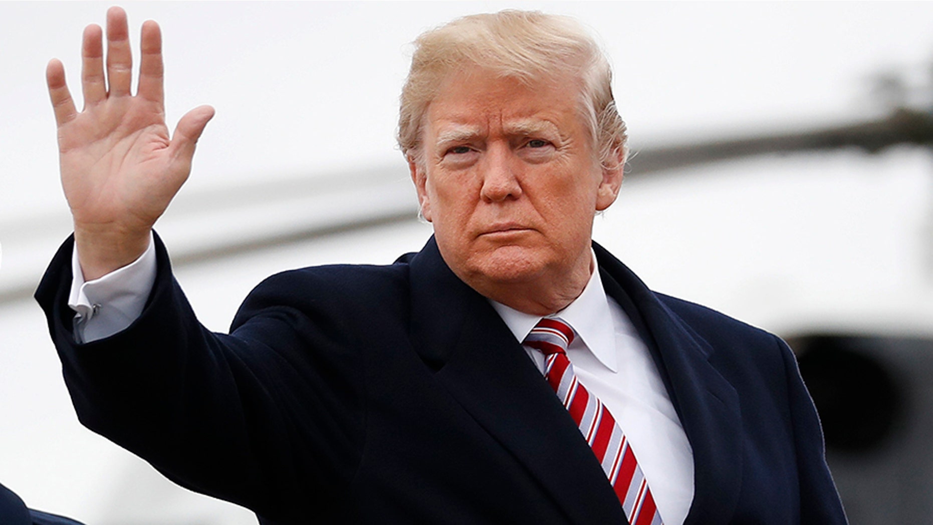 FILE -- Donald Trump waves as he prepares to board Air Force One during his departure from Andrews Air Force Base, Md., Monday, April 16, 2018.