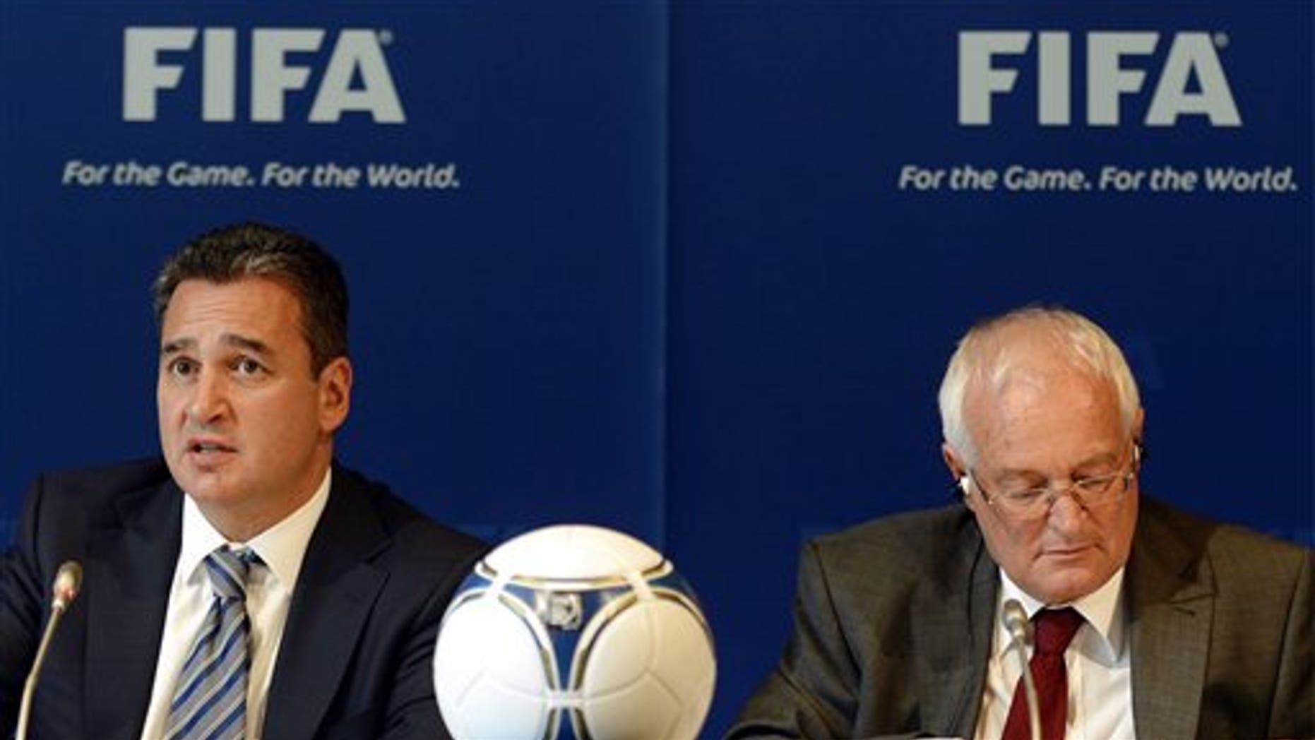 FILE - In this Friday, July 27, 2012 file photo, Chairmen of the two chambers of the new FIFA Ethics Committee Michael Garcia, left, from the US and Joachim Eckert, right, from Germany attend a press conference, at the Home of FIFA in Zurich, Switzerland. FIFA ethics judge Joachim Eckert is unlikely to reach final decisions in the 2018 and 2022 World Cup bidding corruption probe until early next year. FIFA has cleared Russia and Qatar of any wrongdoing in their winning bids for the next two World Cups. German judge Joachim Eckert formally closed FIFAs probe into the 2018 and 2022 World Cup bidding contests on Thursday, almost four years after the vote by the governing body's scandal-tainted executive committee. Eckert noted wrongdoing among the 11 bidding nations in a 42-page summary of FIFA prosecutor Michael Garcias investigations. (AP Photo/Keystone, Walter Bieri, File)