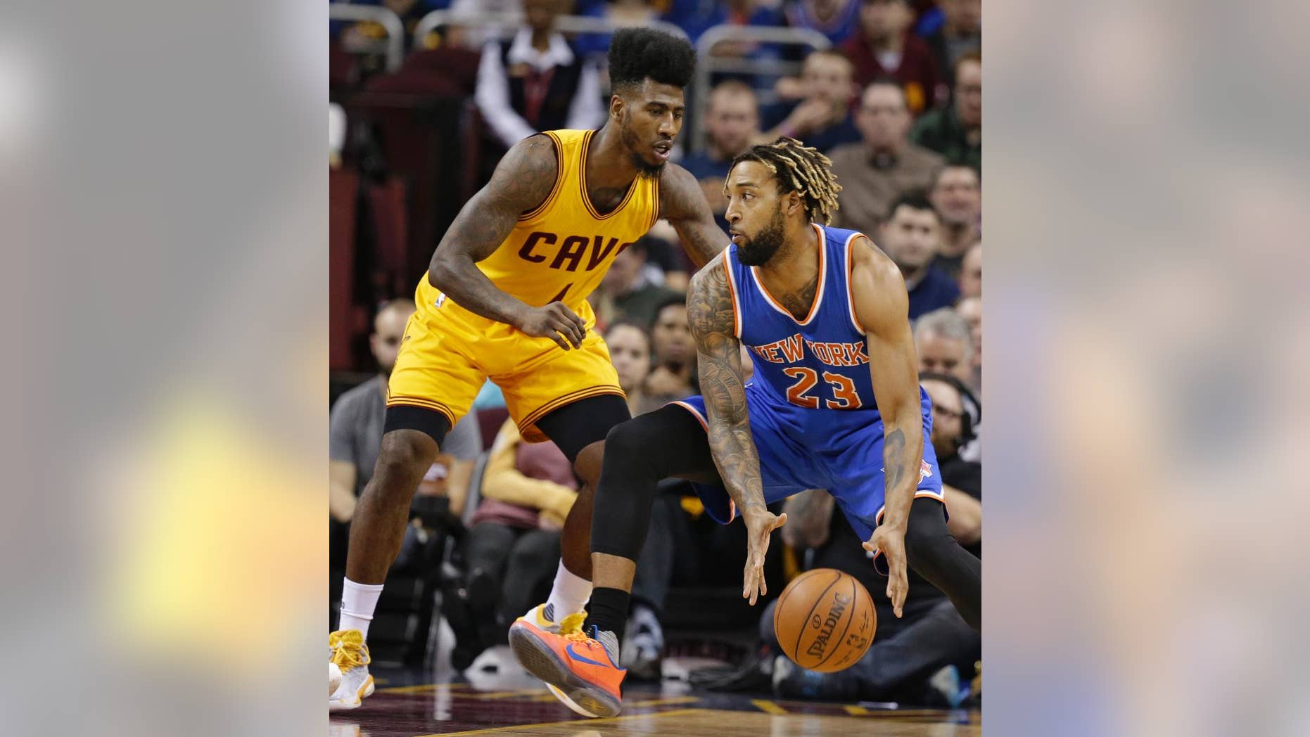 New York Knicks' Derrick Williams (23) drives past Cleveland Cavaliers' Iman Shumpert (4) in the first half of an NBA basketball game Wednesday, Dec. 23, 2015, in Cleveland. The Cavaliers won 91-84. (AP Photo/Tony Dejak)