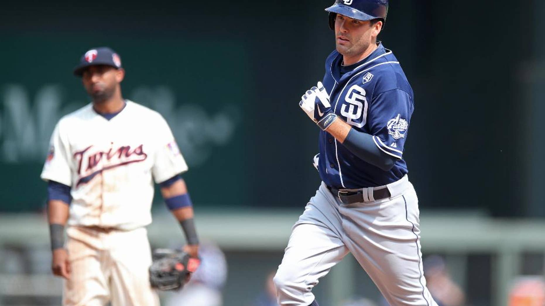 San Diego Padres' Seth Smith, right, rounds the bases on his decisive solo home run off Minnesota Twins relief pitcher Anthony Swarzak in the 10th inning of a baseball game, Wednesday, Aug. 6, 2014, in Minneapolis. The Padres won 5-4. (AP Photo/Jim Mone)