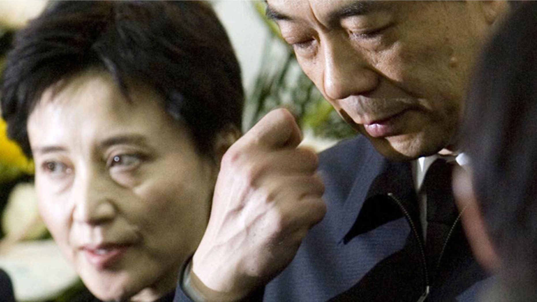 FILE - In this Jan. 17, 2007 file photo, former Chongqing Communist Party Secretary Bo Xilai, right, accompanied by his wife Gu Kailai, attends a funeral for his father in Beijing.