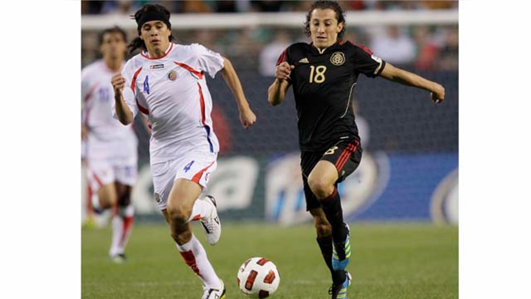 Mexico's Andres Guardado, right, controls the ball past Costa Rica's Jose Salvatierra during the second half of a CONCACAF Gold Cup soccer match at Soldier Field on Sunday, June 12, 2011, in Chicago. Mexico won 4-1. (AP Photo/Nam Y. Huh)