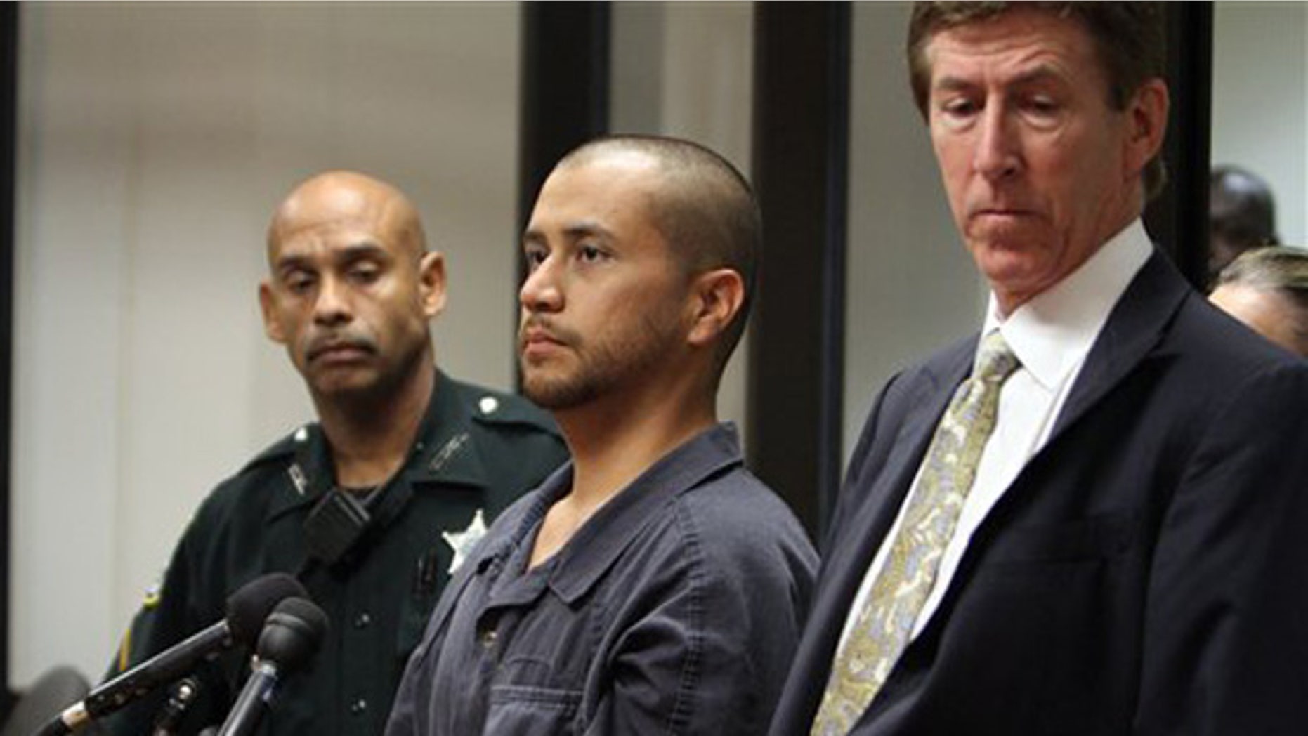 George Zimmerman, center, stands with his attorney Mark O'Mara, right, and a Seminole County Deputy during a court hearing Thursday April 12, 2012, in Sanford, Fla. Zimmerman has been charged with second-degree murder in the shooting death of the 17-year-old Trayvon Martin. (AP Photo/Gary W. Green, Orlando Sentinel, Pool)