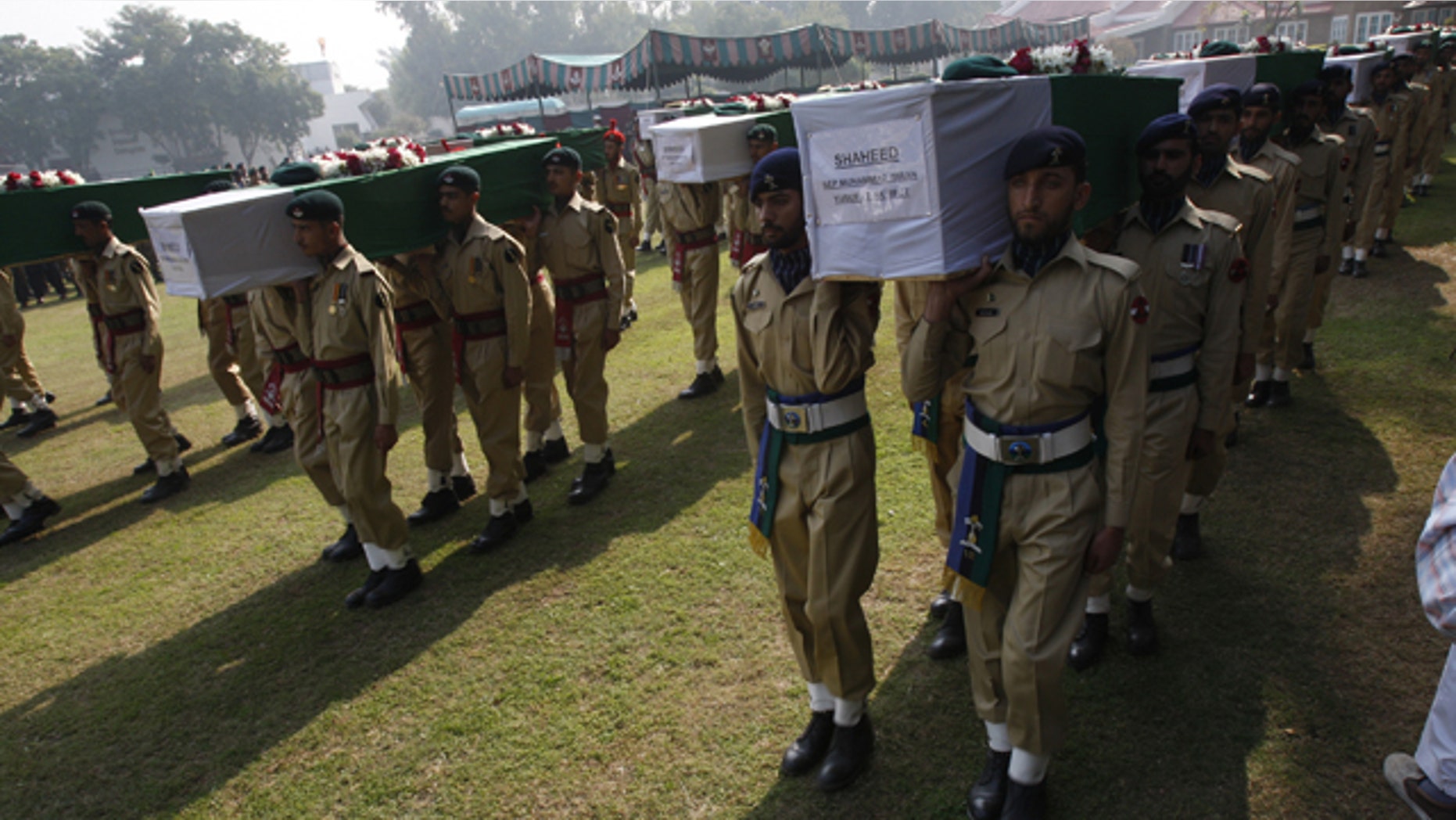 Nov. 27: Pakistan army soldiers carry coffin of Saturday's NATO attack victims for funeral in Peshawar, Pakistan.