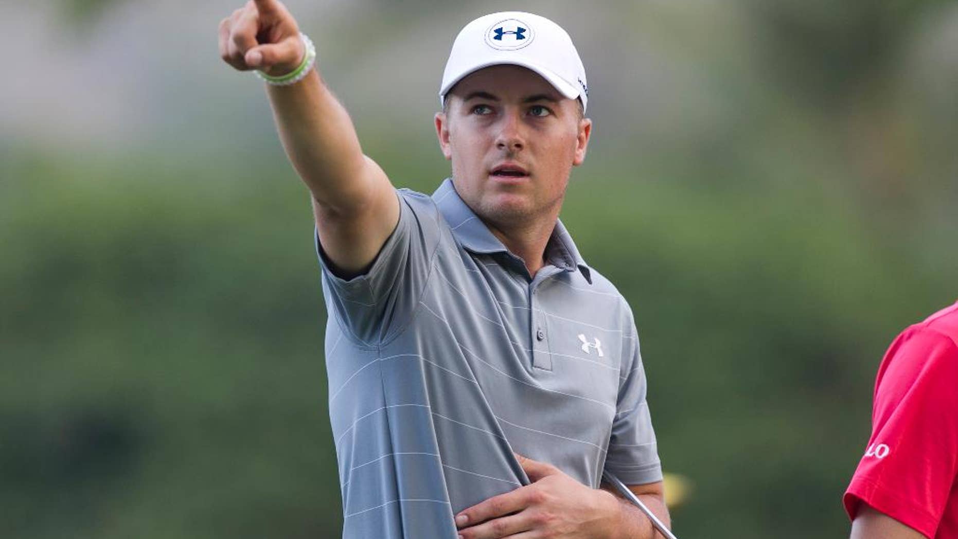 While walking on the 11th fairway with playing partner Justin Thomas (not pictured), Jordan Spieth points to something off the course during the first round of the Sony Open golf tournament, Thursday, Jan. 12, 2017, in Honolulu. (AP Photo/Marco Garcia)