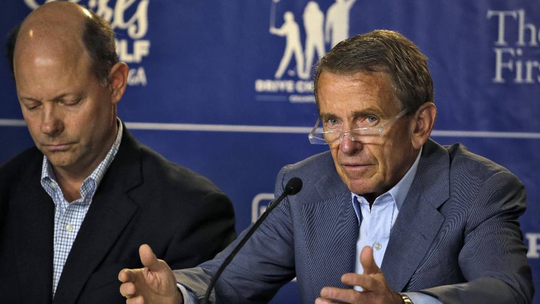 PGA Tour Commissioner Tim Finchem, right, gestures during a golf industry news conference at The Players Championship golf tournament Wednesday, May 6, 2015, in Ponte Vedra Beach, Fla. Looking on is Mike Davis, Executive Director of the USGA. (AP Photo/Chris O'Meara)