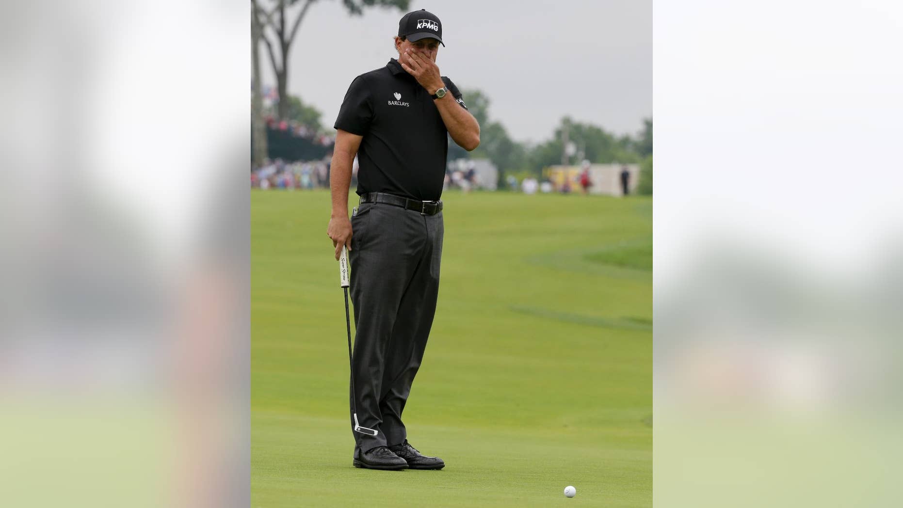 Phil Mickelson watches his putt on the 10th hole during the rain delayed first round of the U.S. Open golf championship at Oakmont Country Club on Friday, June 17, 2016, in Oakmont, Pa. (AP Photo/Gene J. Puskar)