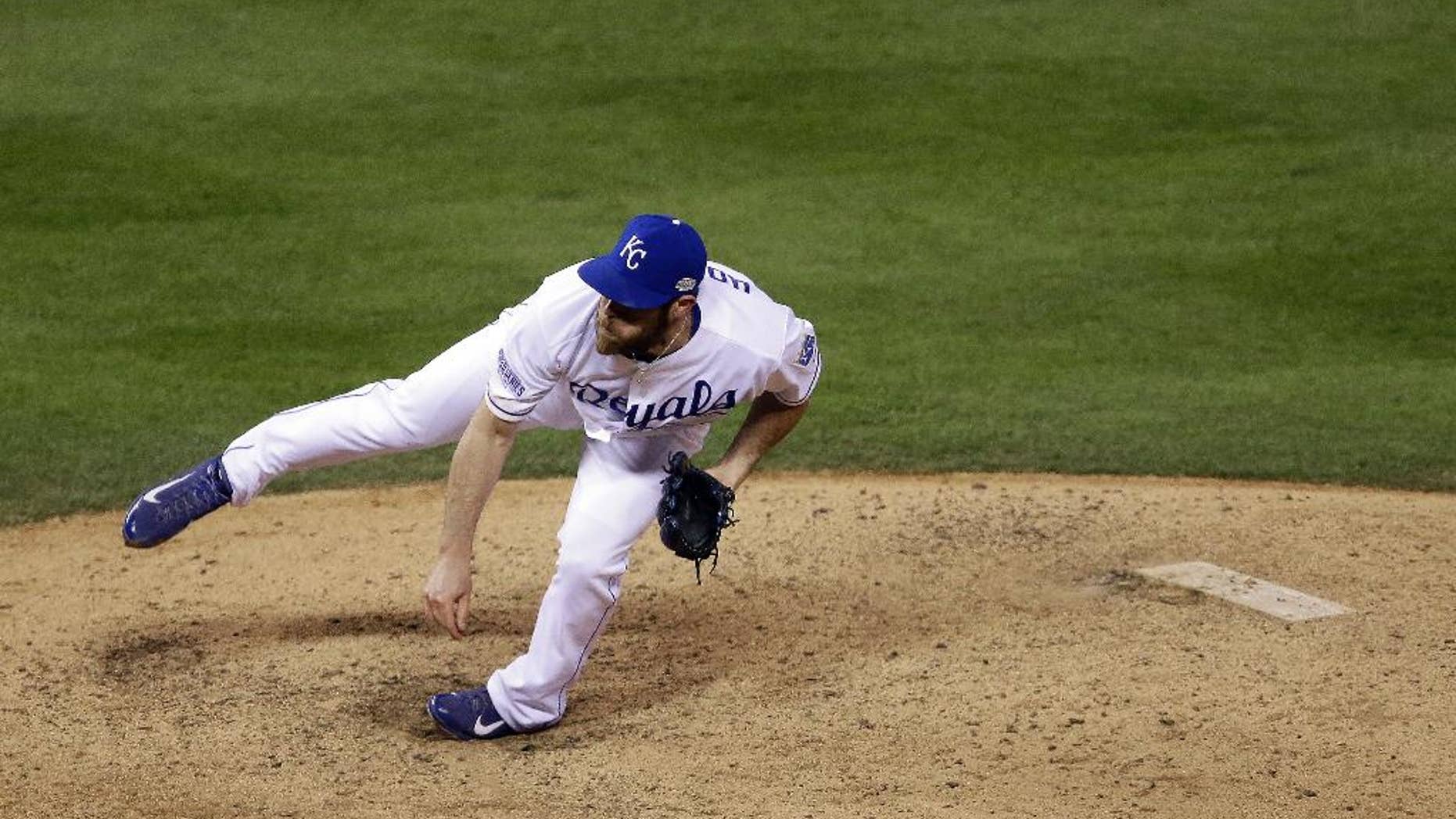 Kansas City Royals pitcher Greg Holland throws during the ninth inning of Game 7 of baseball's World Series against the San Francisco Giants Wednesday, Oct. 29, 2014, in Kansas City, Mo. (AP Photo/Jeff Roberson)