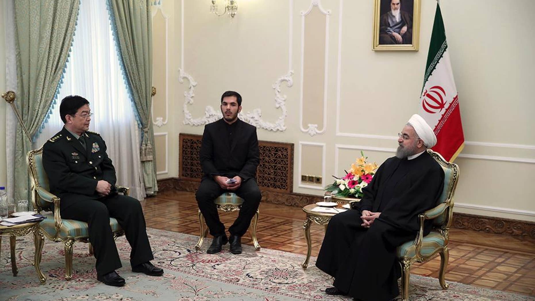 In this photo released by an official website of the office of the Iranian Presidency, President Hassan Rouhani, right, meets with Chinese Defense Minister Chang Wanquan, left, at his office, in Tehran, Iran, Tueday, Nov. 15, 2016. An unidentified interpreter sits at center. (Iranian Presidency Office via AP)