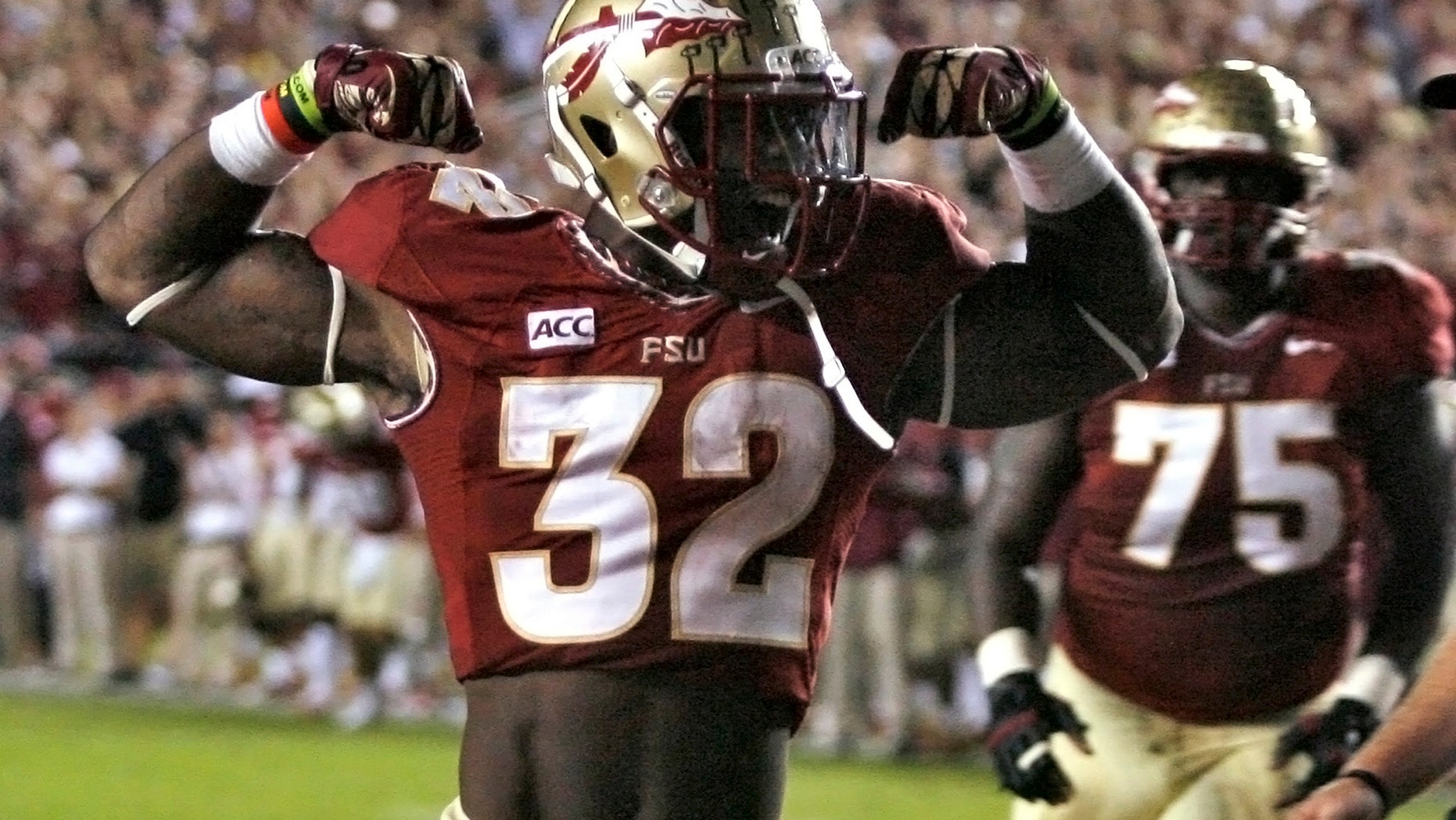 Florida State running back James Wilder Jr. (32) celebrates after scoring a touchdown against Miami during the second quarter of an NCAA college football game Saturday, Nov. 2, 2013, in Tallahassee, Fla. At right is offensive linesman Cameron Erving (75). (AP Photo/Phil Sears)