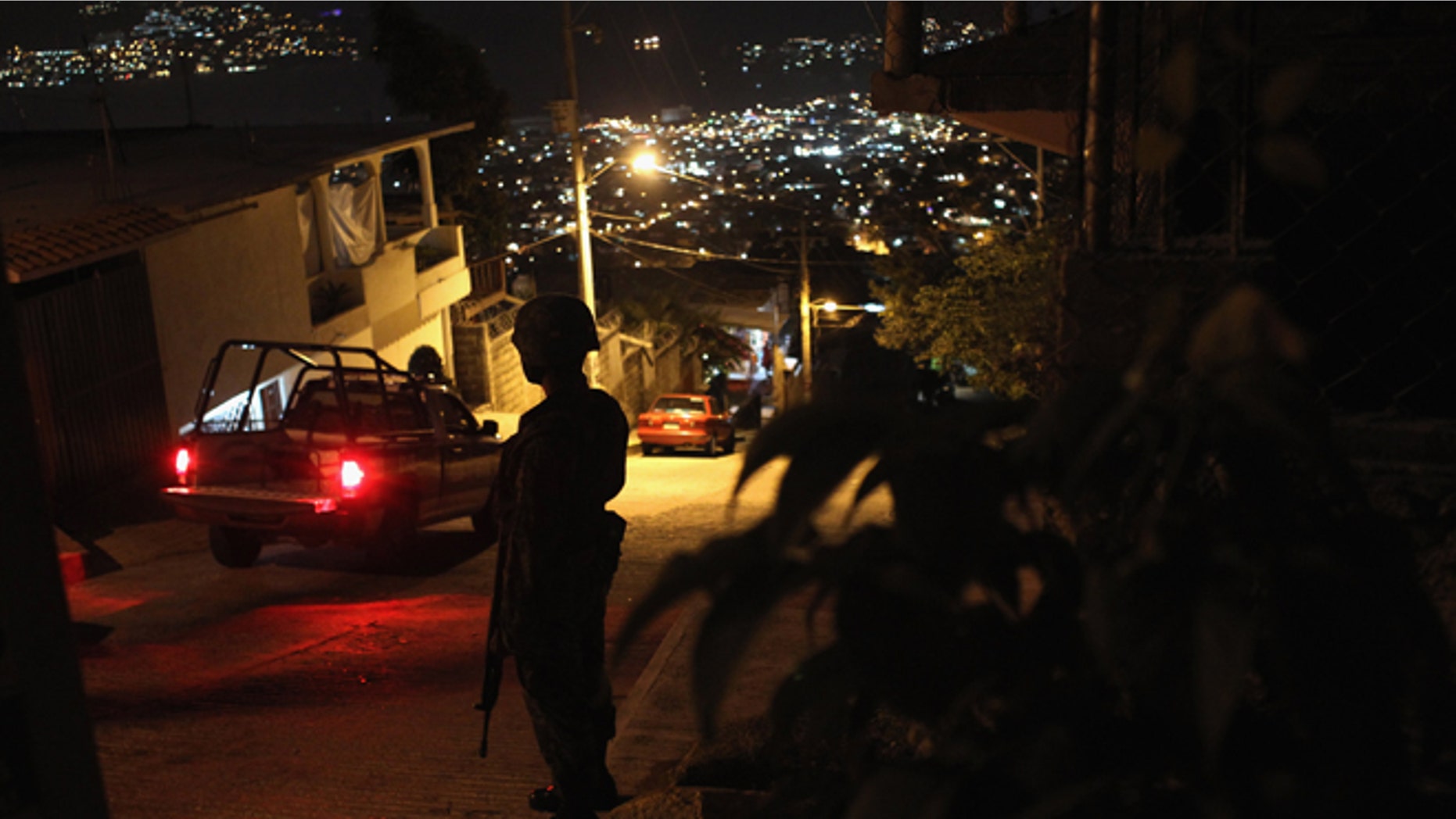ACAPULCO, MEXICO - MARCH 03: A Mexican army soldier stands guard at a suspected drug-related murder site March 3, 2012 in Acapulco, Mexico. A forensics team excavated five corpses from the floor of an abandoned house. Officials said the five victims were apparently buried alive in concrete. Drug violence has surged in the coastal resort in the last year, making Acapulco the second most deadly city in Mexico after Juarez. One of Mexico's top tourist destinations, Acapulco has suffered a drop in business, especially from foreign tourists, due to the violence. Toursim accounts for about 70 percent of the economy of Acapulco's state of Guerrero and 9 percent of Mexico's economy. (Photo by John Moore/Getty Images)