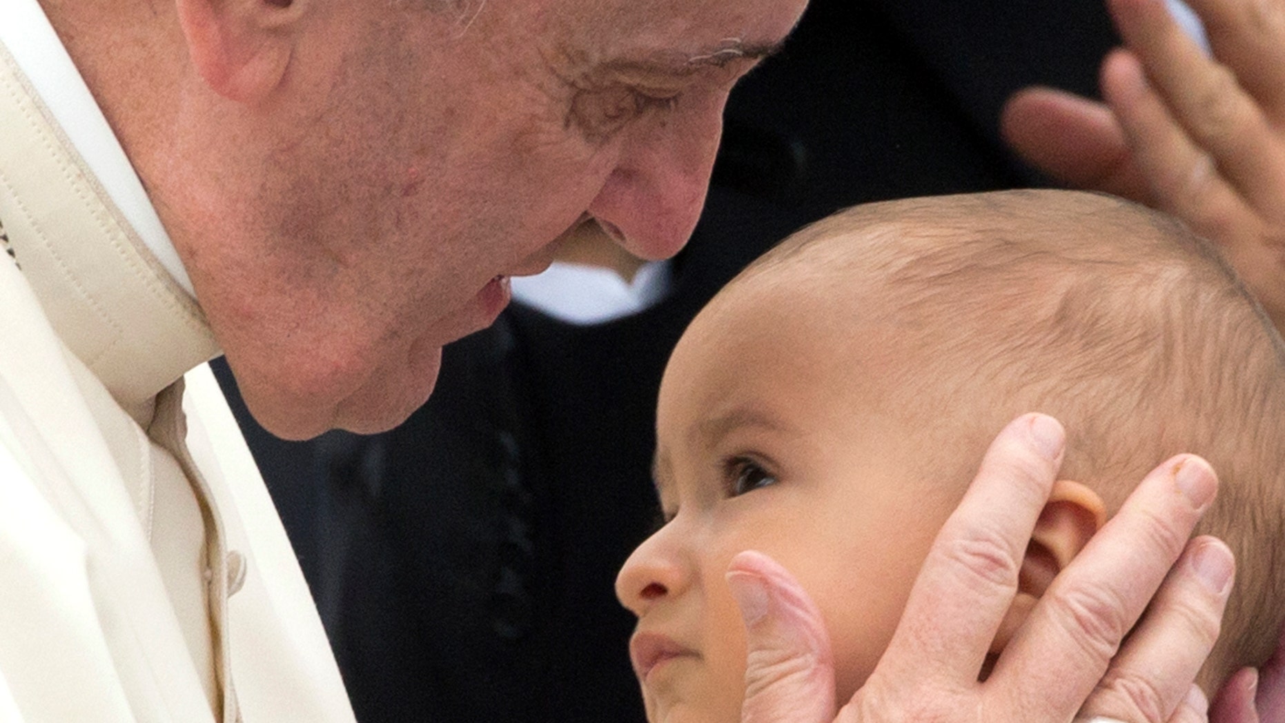 Pope Francis caresses a baby during his weekly general audience in St. Peter's Square at the Vatican, Wednesday, Sept. 2, 2015. (AP Photo/Alessandra Tarantino)