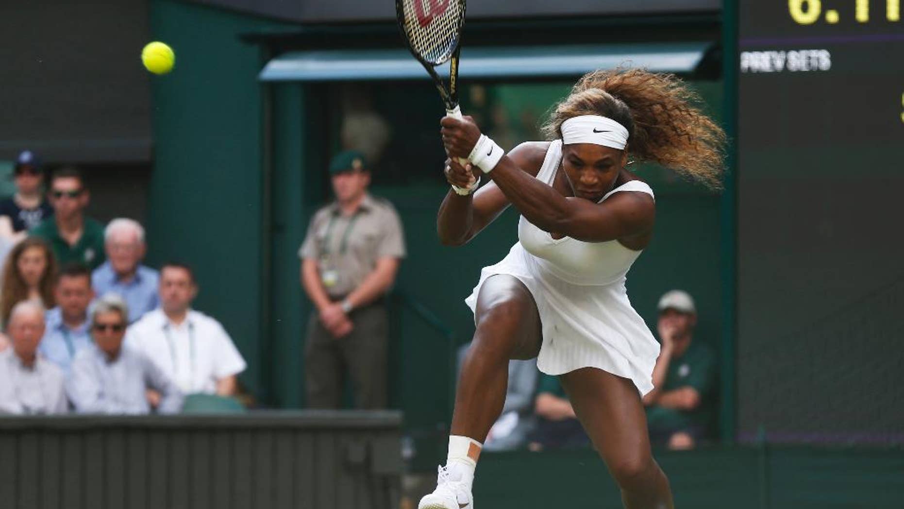 Serena Williams of U.S. plays a return to Anna Tatishvili of U.S. during their first round match at the All England Lawn Tennis Championships in Wimbledon, London, Tuesday, June 24, 2014. (AP Photo/Sang Tan)