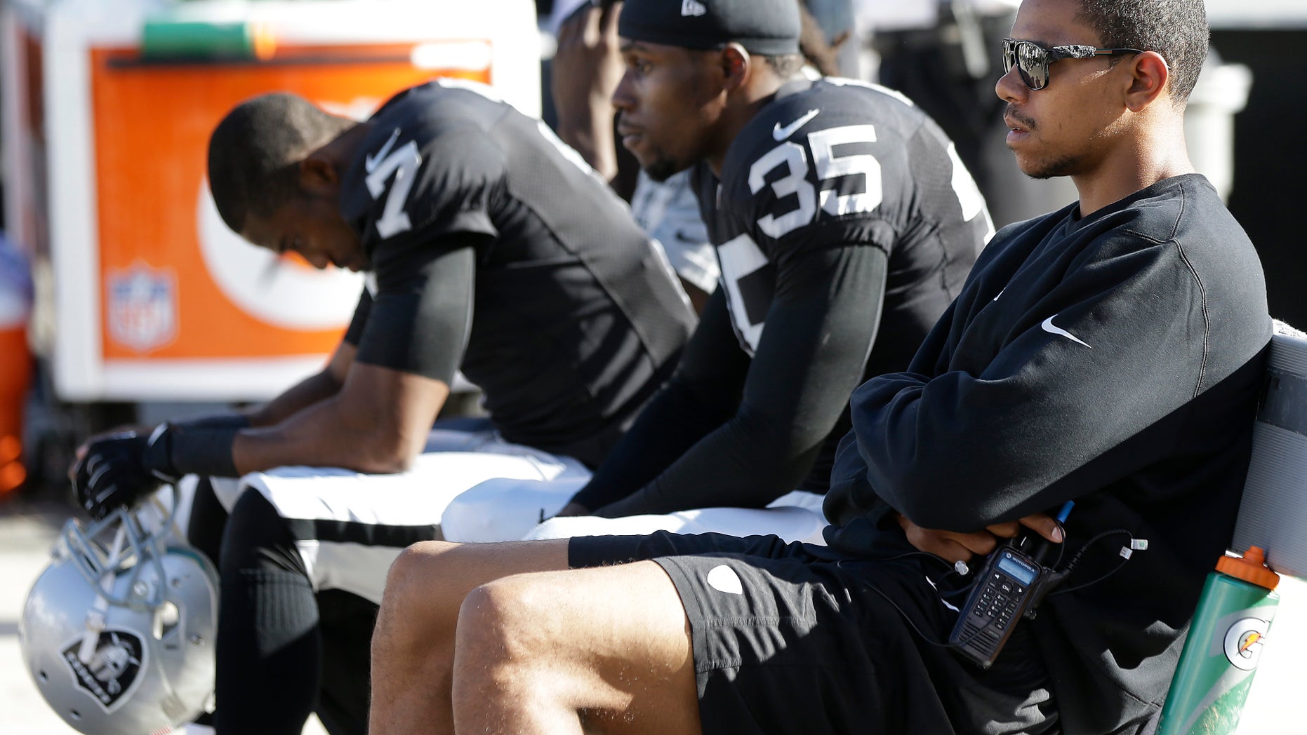 Oakland Raiders quarterback Terrelle Pryor, right, defensive back Chimdi Chekwa (35), and punter Marquette King (7) sit on the bench during the fourth quarter of the Raiders' 24-14 loss to the Washington Redskins in an NFL football game Sunday, Sept. 29, 2013, in Oakland, Calif. (AP Photo/Marcio Jose Sanchez)