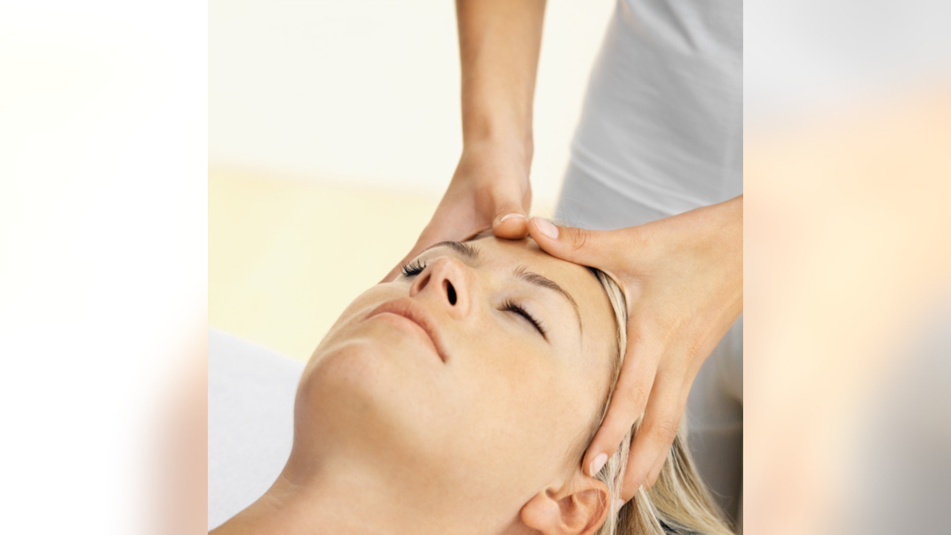Close up of a woman receiving a head massage