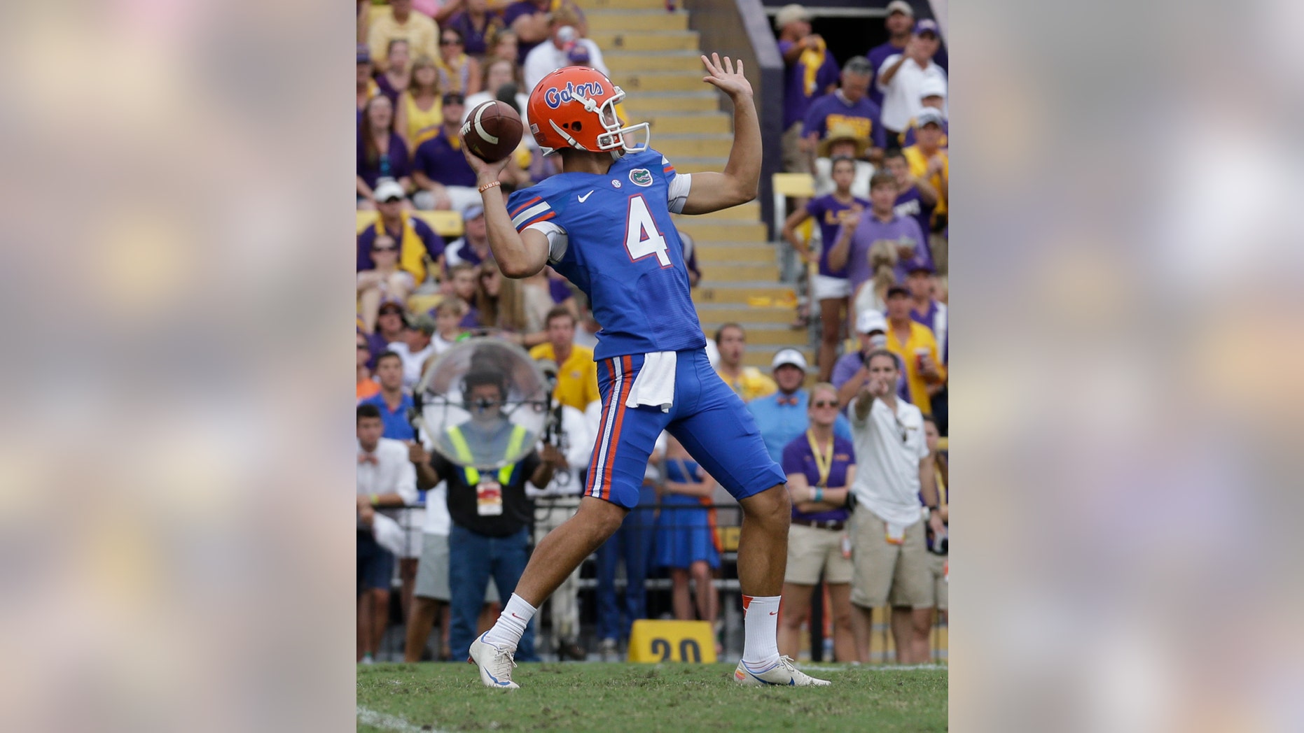 Florida punter Kyle Christy (4) passes on a fake punt in the second half of an NCAA college football game against LSU in Baton Rouge, La., Saturday, Oct. 12, 2013. LSU won 17-6. (AP Photo/Gerald Herbert)