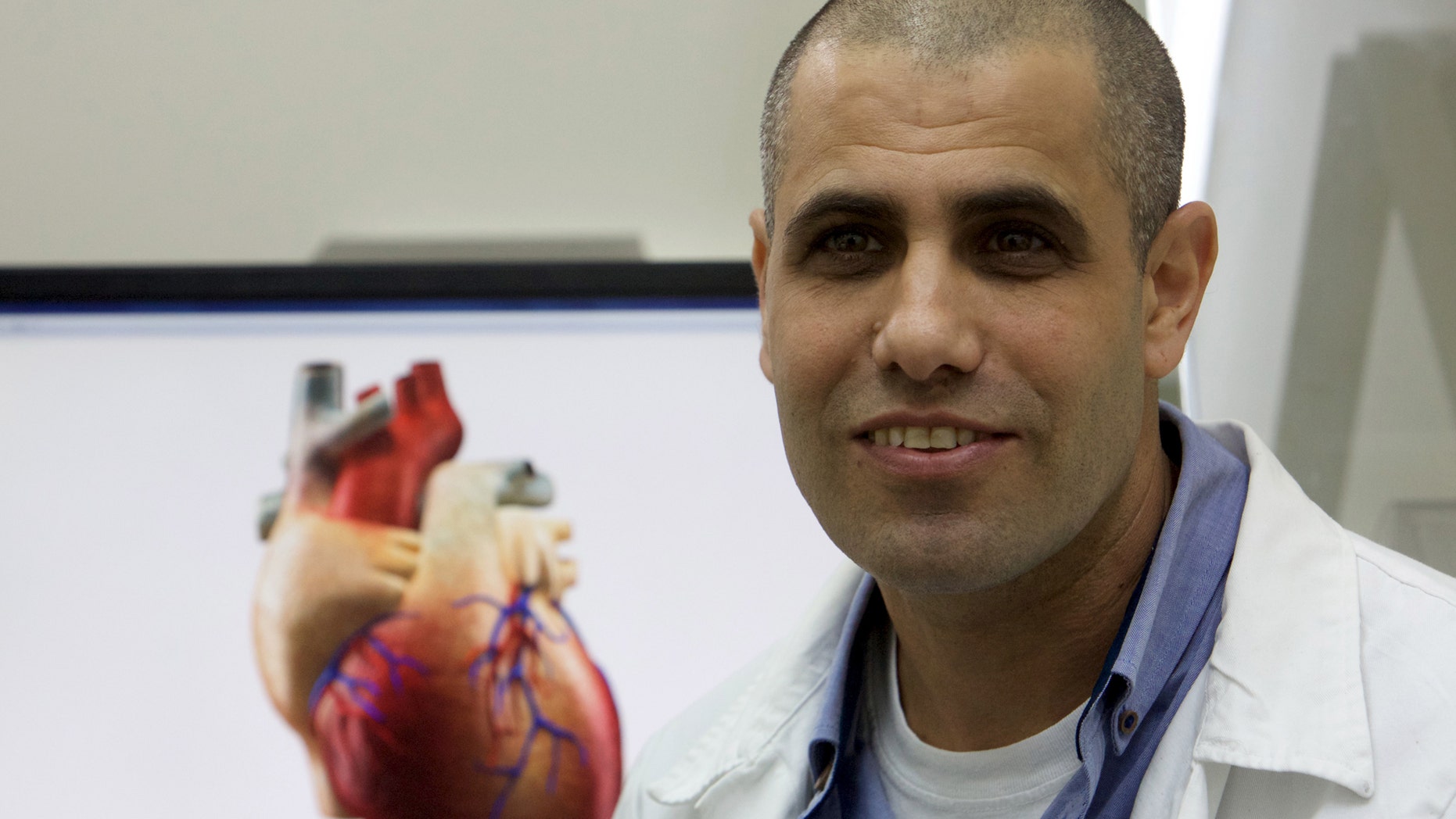 File photo: Professor Tal Dvir speaks during their interview with Reuters on his team's development of a 3D printed patch comprised of lab-grown heart tissue and nano-electronics that could potentially revolutionize the treatment of heart disease, at a laboratory in Tel Aviv University March 16, 2016. Picture taken March 16, 2016. (REUTERS/ Nir Elias)