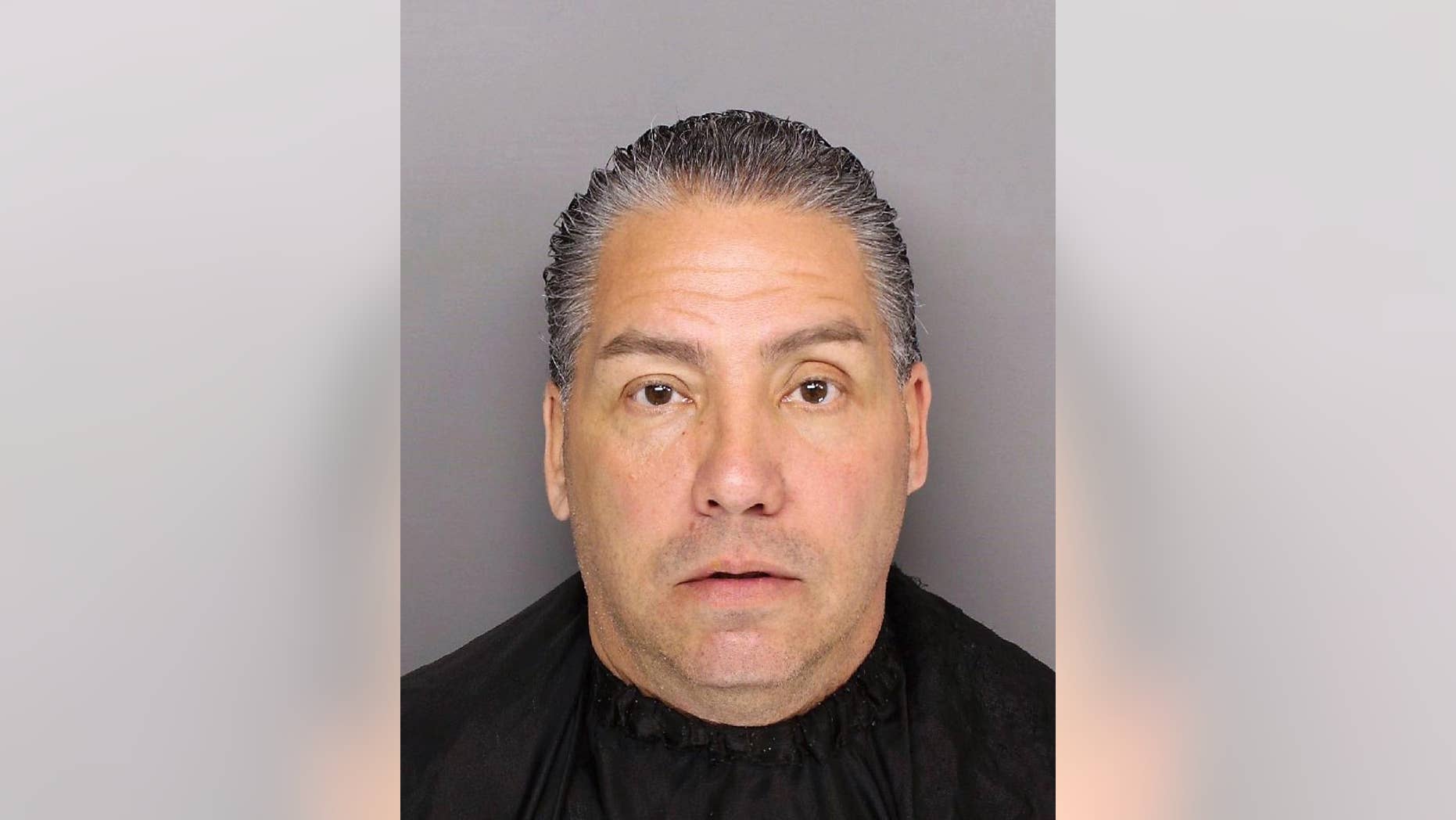 This March 3, 2017 photo provided by Greenville, S.C., police shows Michael Ruiz in Greenville after his arrest on human trafficking charges, including posing as an ICE agent and swindling immigrants out of more than $70,000. Ruiz is among the con artists across the country are taking advantage of a climate of fear among immigrants by posing as federal agents and ordering them pay up or else be detained and deported, authorities and outreach groups say. (Greenville, SC Police Dept. via AP)