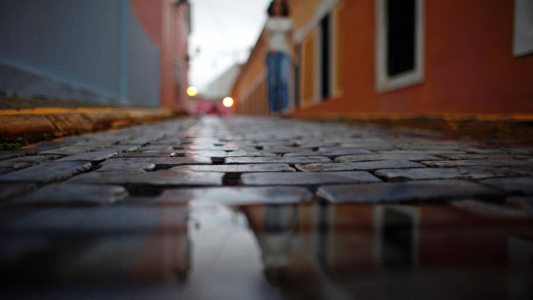 Wet cobblestones are seen on a street during a rainy day in Old San Juan, Puerto Rico, Tuesday, Nov. 4, 2014. Heavy rains caused by a cluster of storms in the northern Caribbean killed at least seven people in Haiti and caused major flooding on Tuesday in the Dominican Republic and Puerto Rico, authorities said. (AP Photo/Ricardo Arduengo)