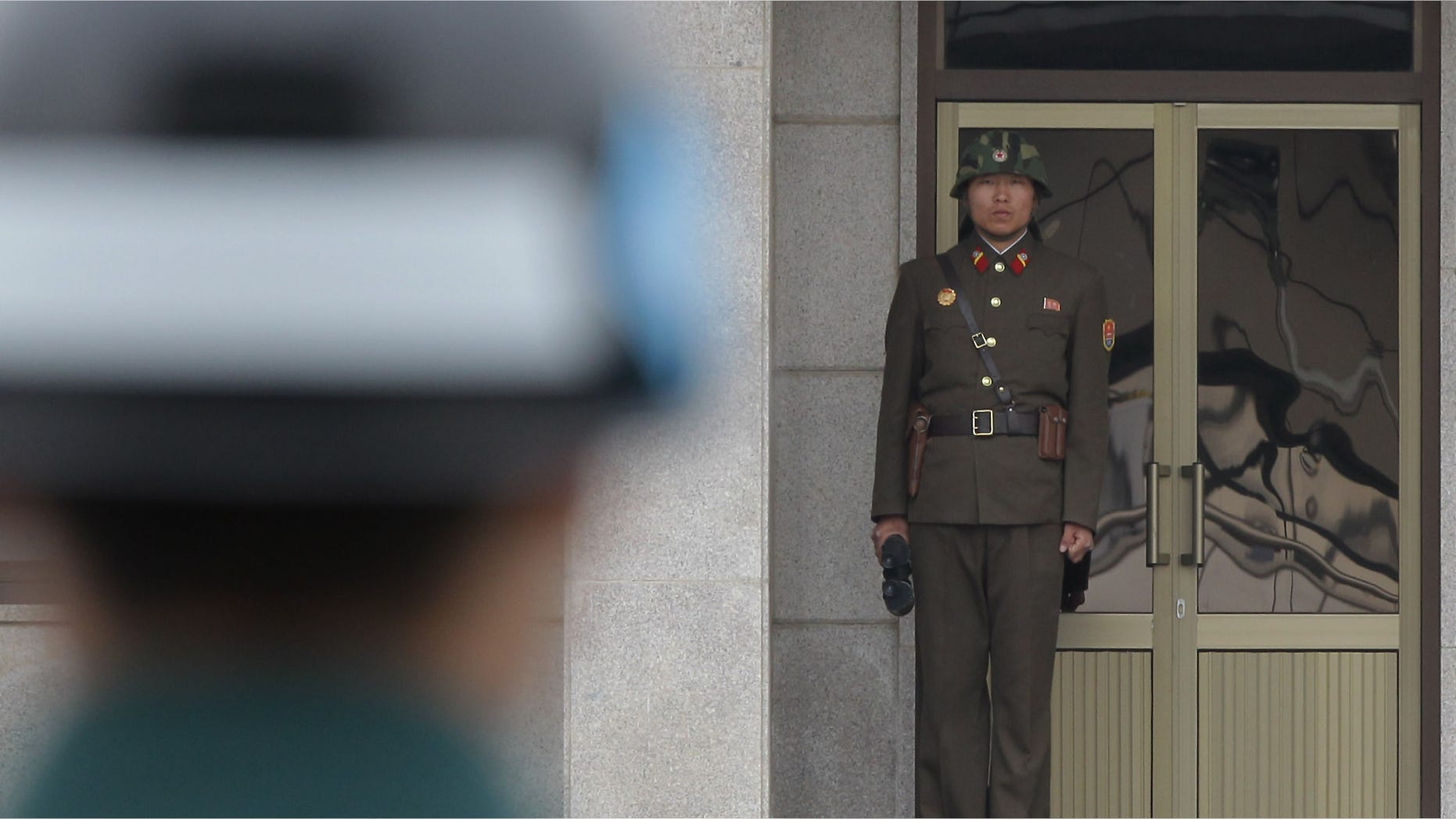 PANMUNJOM, SOUTH KOREA - APRIL 23: A North Korean soldier looks at South Korea across the Korean Demilitarized Zone (DMZ), on April 23, 2013 in Panmunjom, South Korea. The tension at Korean Peninsula remains high as North Korea's ballistic missiles have been ready to launch ahead of North Korean Army foundation celebration day on April 25. (Photo by Chung Sung-Jun/Getty Images)