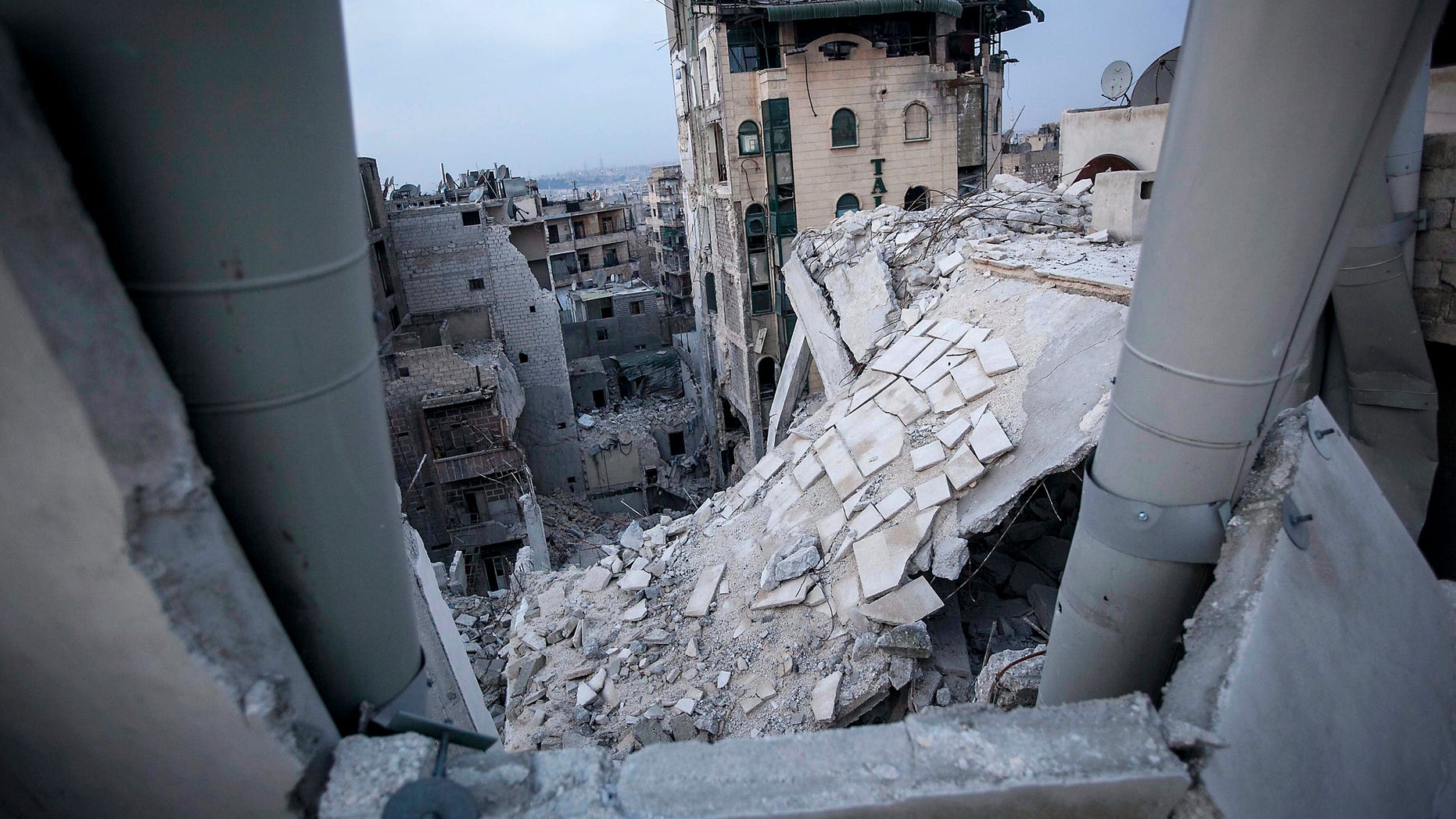FILE - In this Thursday, Nov. 29, 2012 file photo, destroyed buildings, including the Dar Al-Shifa hospital, bottom, lay in ruins following airstrikes in Aleppo, Syria, in this file photo dated Thursday, Nov. 29, 2012. In the summer of 2012 fighting spread to the former commercial capital, Syria's largest city Aleppo, with rebel forces controlling some neighborhoods, but the battle for overall control continues to this day and much of the city lays in ruins. (AP Photo/Narciso Contreras, File)
