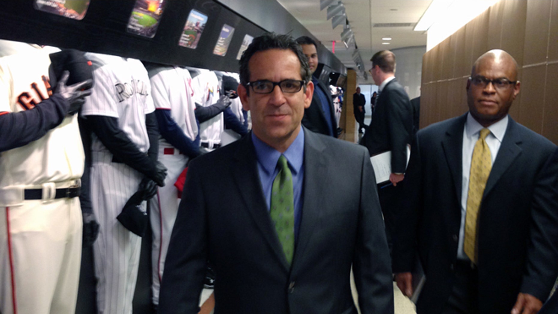 FILE - In this Sept. 30, 2013, file photo provided by Fitzpatrick Communications, Anthony Bosch is escorted by Major League Baseball security person Ric Burnham, right, at MLB headquarters in New York. Federal authorities are charging the owner of a defunct Florida clinic accused of providing steroids and other banned substances to Major League Baseball players, including New York Yankees star Alex Rodriguez. According to Miami federal court records Tuesday, Aug. 5, 2014, Anthony Bosch faced one count of conspiracy to distribute testosterone. (AP Photo/Fitzpatrick Communications)