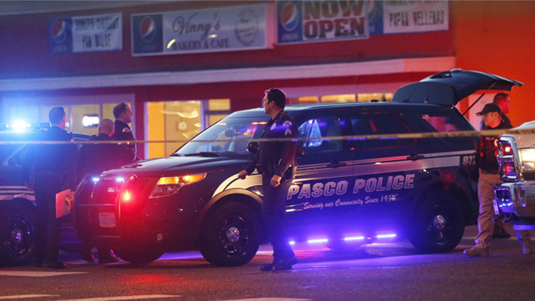 Police investigate the scene of an officer involved shooting Tuesday, Feb. 10. 2015 in Pasco, Wash.