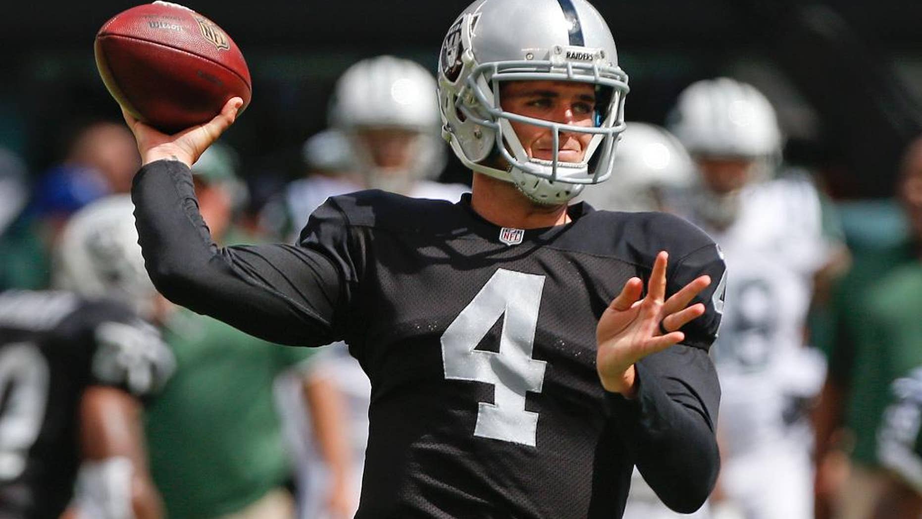 Oakland Raiders quarterback Derek Carr (4) throws a pass during the first half of an NFL football game against the New York Jets Sunday, Sept. 7, 2014, in East Rutherford, N.J. (AP Photo/Seth Wenig)
