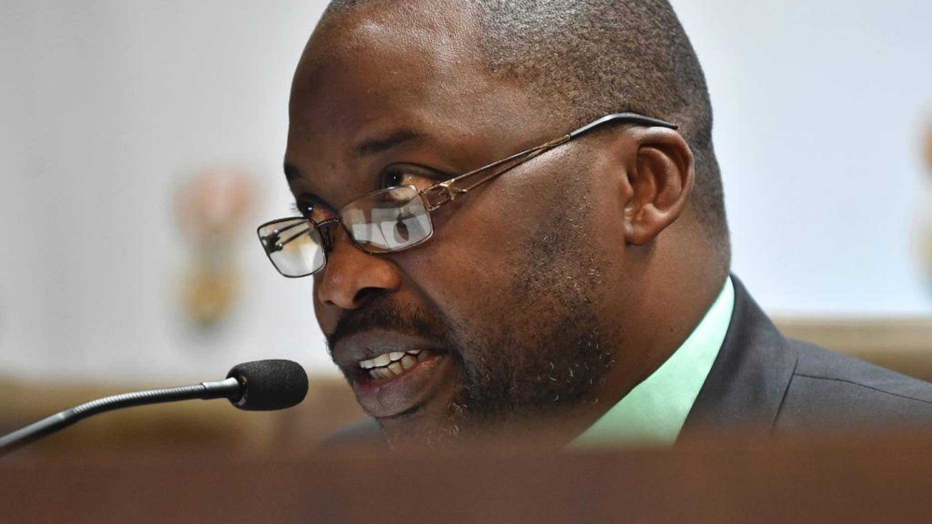 South Africa's minister of justice and correctional services, Michael Masutha, speaks to the press in Pretoria, South Africa, Friday, Oct. 21, 2016. Masutha said South Africa will soon submit a bill in parliament to withdraw from the International Criminal Court making the country the second this week, after Burundi, to move to leave the tribunal that pursues the world's worst atrocities. (AP Photo)
